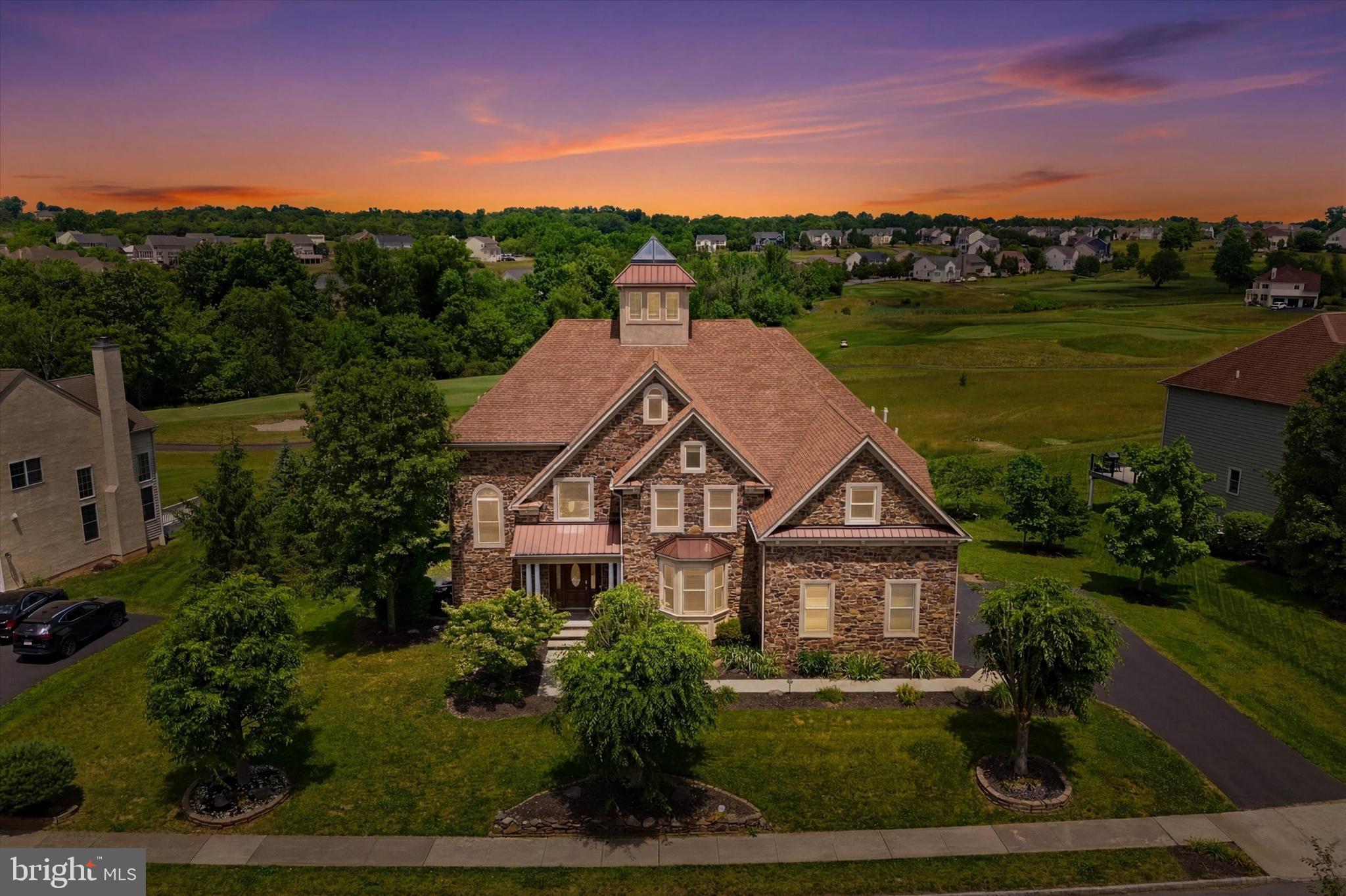 Rare and sought-after, this spectacular Inverness model is truly one of a kind — and one of the finest homes in Lederach Golf Club. Completely rebuilt from the studs during stucco remediation, no detail was overlooked. All stucco was removed and replaced in 2012 with real floor-to-ceiling bluestone and cultured stone (not veneer), new Andersen Architectural E-glass windows and doors, custom woodwork, custom tilework, and a fully integrated smart home system with surround sound, hidden wiring, and smart lighting inside and out.
The dramatic open floor plan spans 7,000+ sq ft and centers around a breathtaking atrium with glass cupola ceiling and glass-enclosed elevator accessing all levels — including the charming indoor koi pond below.
The grand two-story foyer welcomes you with architectural details that flow through formal dining and living rooms into the stunning family room — featuring marble floors, a two-story real bluestone wood-burning fireplace with gas trigger, a 100-year-old oak mantel, and walls of windows with 8-ft sliding glass doors that open to the 1,000+ sq ft cedar and slate deck with glass balusters that illuminate at night. The views of the golf course from this deck are simply spectacular.
The gourmet kitchen is a chef's dream with stainless steel appliances, double oven, expansive island, Corian countertops, and a walk-in pantry — all opening to a sunny breakfast room and the family room beyond.
Upstairs, the grand master suite features double doors, a stone accent wall, sitting room, private balcony overlooking the 11th hole, a spa-like ensuite with jetted tub, walk-in shower with ceiling speakers, and two custom walk-in closets. Three additional bedrooms — including a princess suite and a jack-and-jill — complete the upper level.
The lower level offers a recreation room, flex room (6th bedroom or home theater), and full bath. A second great room stuns with two stories of windows, floor-to-ceiling bluestone, and double glass doors to a covered flagstone patio — more breathtaking golf course views await.
Outside: professional landscaping, smart outdoor lighting, a wide accessibility ramp, reinforced deck space for a future hot tub, and a 3-car garage with brand new garage doors & an EV charger as well!
Minutes to the PA Turnpike, Skippack Village, and major pharmaceutical corridors.
This is not just a home — it's a lifestyle.
Join me for a tour, showings start Wednesday 6/17.