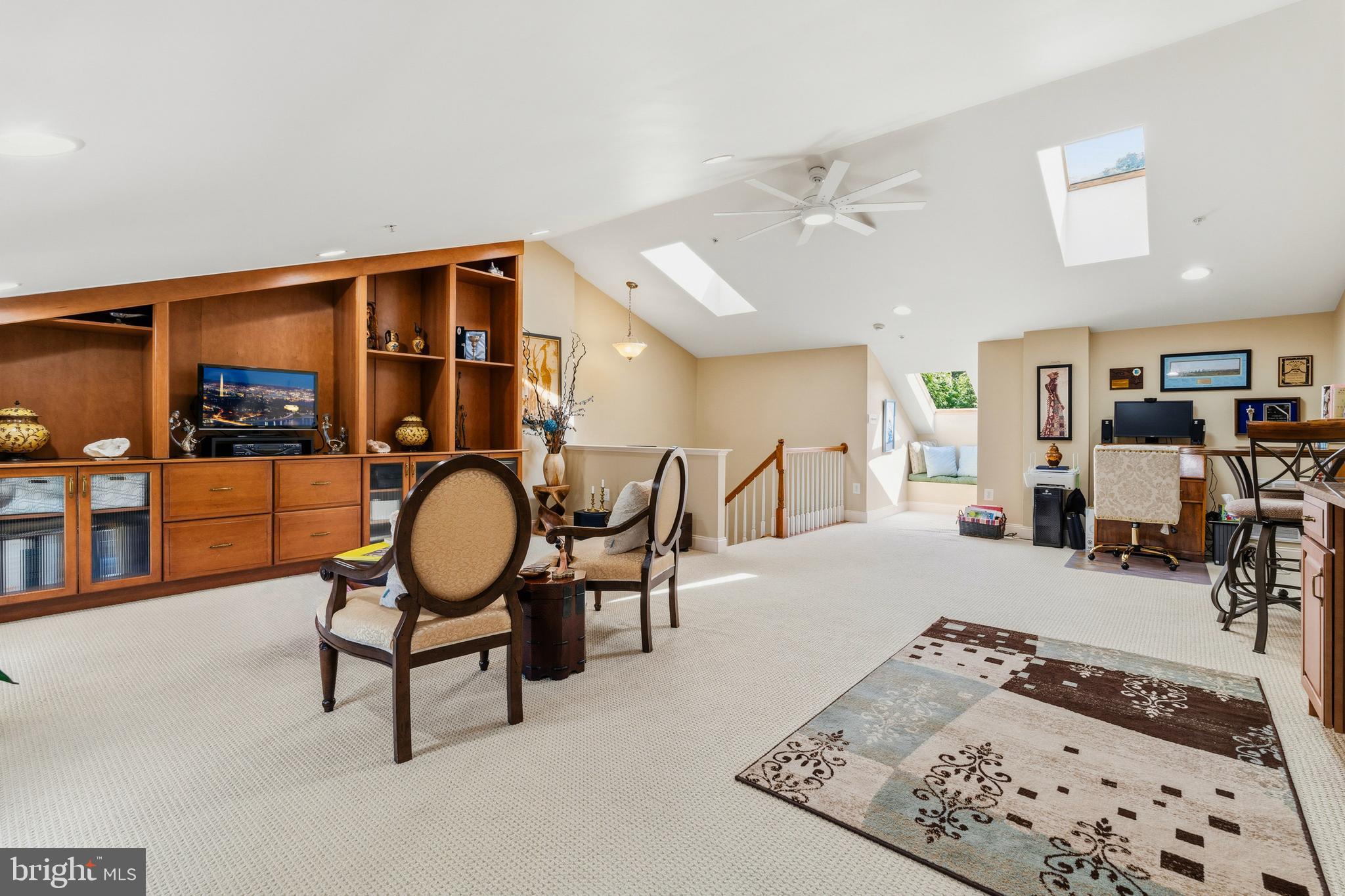 Priced to sell with a massive $25,000 price adjustment, this exceptional FOUR level brick townhouse stands completely apart from the competition, featuring a private fourth floor loft that adds over 500 square feet of wide open, versatile living space.

Delivering unmatched turnkey peace of mind, this former model home is front-loaded with value and conveys with thousands of dollars in premium, included audio visual equipment. The private lower level theater room comes fully loaded with a Mitsubishi 3D projector, a Sony AV receiver, a Pioneer AV receiver, and a 6 channel power speaker selector that runs the hardwired ceiling speakers spanning the main level and upper hallway. Giving buyers total investment protection, every major mechanical system and appliance has been recently updated, including a new water heater (2022), a new central AC unit (2023), a new refrigerator (2024), and a brand new GE double oven combo with built in air fryer and convection technology (May 2025).

Spanning over 2,500 square feet of meticulously upkept living space, the home features a rare, flowing main floor layout with gleaming hardwoods, double crown molding, a formal dining room, and a cozy family room anchored by a working fireplace with an integrated blower. The kitchen open plan transitions smoothly to your low maintenance composite privacy deck and lower stone patio, both backing directly to a peaceful tree line for premium backyard privacy.

Upstairs features three spacious bedrooms, two full bathrooms, and custom built in closet cabinetry with integrated drawers in every room. Just above this level sits the sunlit 500+ square foot loft oasis, complete with an opening skylight that lets in an incredible breeze. The fully finished walk out basement serves as your stadium sound movie theater alongside a half bath with an existing rough in for an easy full bath conversion. Complete with an EV charger ready two car garage, direct access to the community's miles of nature trails, resort style pools, and an available 3.25% assumable VA loan, this property is a rare lifestyle upgrade at an unbeatable new price point.