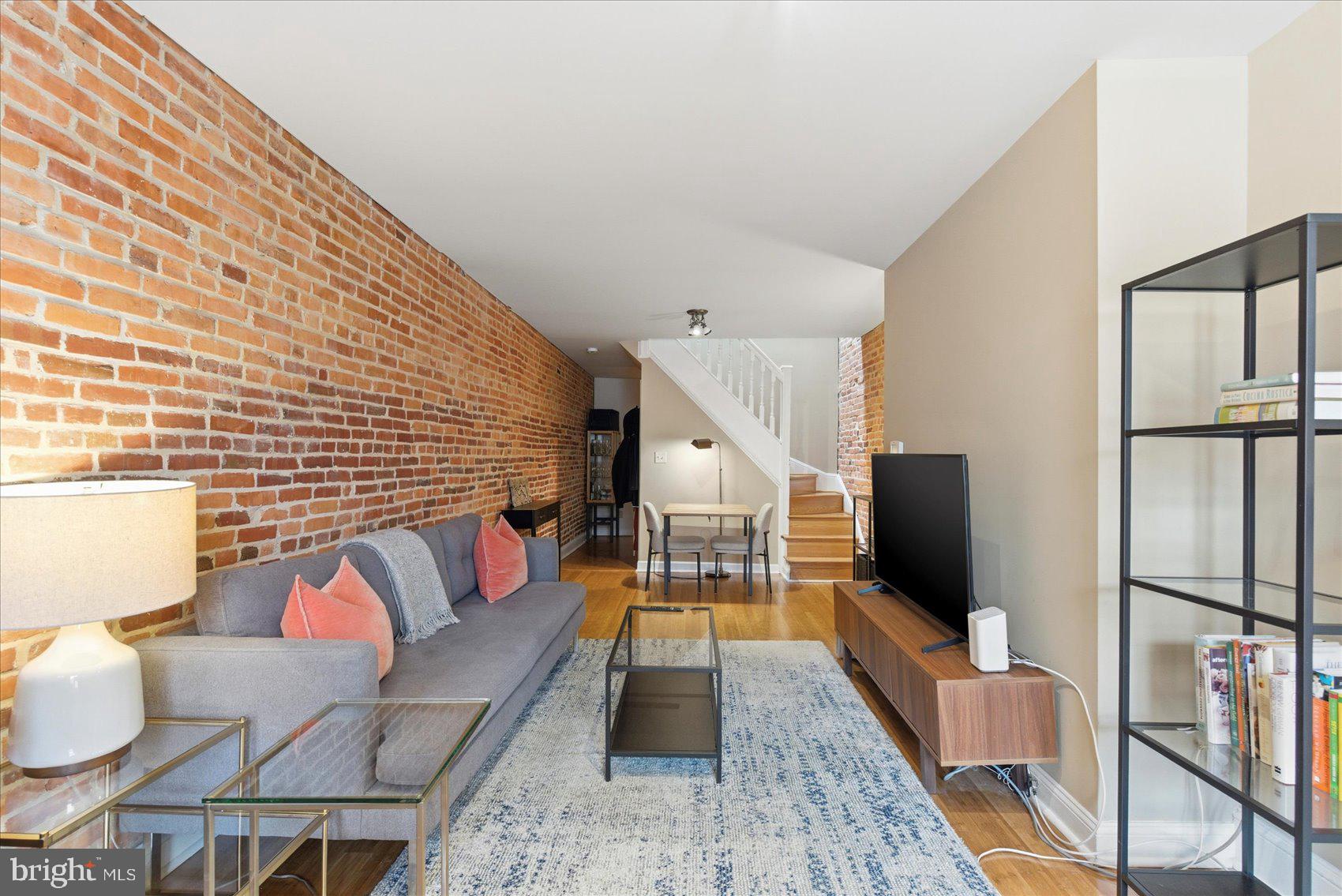 Welcome to this beautifully updated Federal Hill rowhome, ideally located just one block from the Inner Harbor. This 3-bedroom, 1.5-bath home features gorgeous bamboo flooring throughout and a warm, inviting main level accented by an exposed brick wall that adds timeless character.

The open main level offers comfortable living and dining space, complemented by a conveniently located half bath—perfect for guests. The updated kitchen showcases stainless steel appliances and a sleek, modern design that flows seamlessly for everyday living and entertaining. Ceiling fans add comfort throughout the home, while the upper levels include three well-appointed bedrooms and a full bath.

Step outside to the rooftop deck and take in breathtaking panoramic views of Baltimore City, ideal for relaxing or hosting guests. A private parking pad in the rear provides rare convenience in this highly desirable neighborhood.

The unfinished basement is just waiting for your personal touch, offering the opportunity to add even more living space to this already great home. Just steps from the Inner Harbor, local restaurants, shops, and shops, and within walking distance to Fort McHenry, this home delivers the perfect blend of historic charm, modern updates, and unbeatable Federal Hill living.