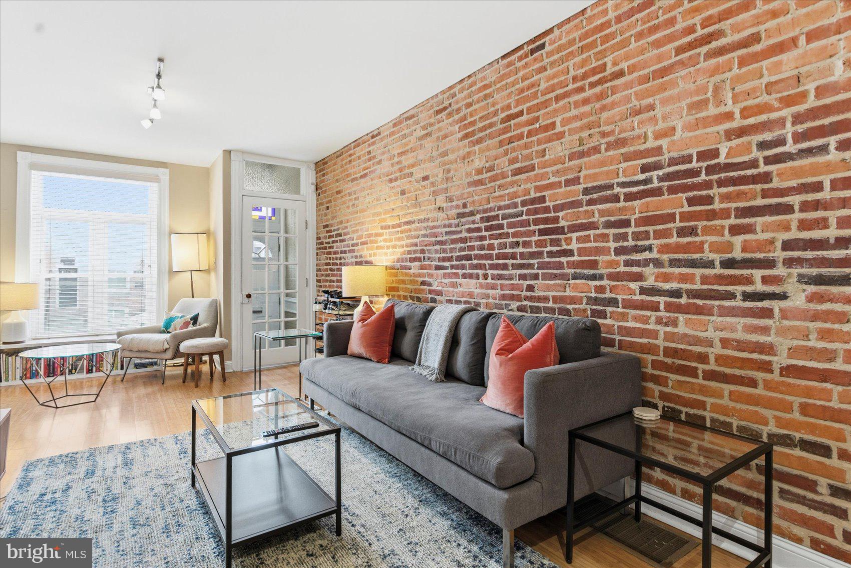 Welcome to this beautifully updated Federal Hill rowhome, ideally located just one block from the Inner Harbor. This 3-bedroom, 1.5-bath home features gorgeous bamboo flooring throughout and a warm, inviting main level accented by an exposed brick wall that adds timeless character.

The open main level offers comfortable living and dining space, complemented by a conveniently located half bath—perfect for guests. The updated kitchen showcases stainless steel appliances and a sleek, modern design that flows seamlessly for everyday living and entertaining. Ceiling fans add comfort throughout the home, while the upper levels include three well-appointed bedrooms and a full bath.

Step outside to the rooftop deck and take in breathtaking panoramic views of Baltimore City, ideal for relaxing or hosting guests. A private parking pad in the rear provides rare convenience in this highly desirable neighborhood.

The unfinished basement is just waiting for your personal touch, offering the opportunity to add even more living space to this already great home. Just steps from the Inner Harbor, local restaurants, shops, and shops, and within walking distance to Fort McHenry, this home delivers the perfect blend of historic charm, modern updates, and unbeatable Federal Hill living.