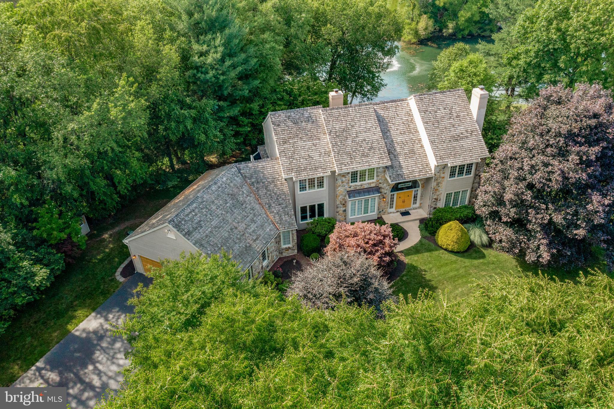 Welcome to 1220 Fieldstone Dr., West Chester, PA in the community of Deer Pointe. This impeccably maintained home is ideally situated at the end of a tranquil cul-de-sac on a sprawling 1.9-acre lot with serene pond views. It is within the prestigious West Chester School District, including Rustin High School. Step into the grandeur of this residence through a 2-story center entrance foyer adorned with a turned oak staircase. The formal living room boasts hardwood floors, double crown molding, and a cozy wood-burning fireplace. Through elegant glass French doors with a transom top, discover a professional office offering picturesque pond views. Enjoy intimate dinners in the formal dining room featuring hardwood floors, double crown molding, and chair rail details. Barn doors separate the dining room from the impressive 2-story family room, highlighted by a floor-to-ceiling stone gas fireplace flanked by twin French doors with feature glass above. The spacious kitchen is a chef's delight with a center island, pendant lighting, stainless steel appliances, and granite countertops. Adjacent is a separate breakfast area that opens onto a delightful, large screened porch, perfect for enjoying morning coffee or evening relaxation. Off the kitchen, you'll find a spacious mud room/laundry room complete with cabinets and a laundry sink, offering convenience and organization. There are formal and informal powder rooms for guests' comfort and convenience. Ascend to the second floor where the expansive master suite awaits, featuring a tray ceiling, a generous walk-in closet, and a luxurious master bathroom. The master bath is appointed with double bowl waterfall vanities, a soaking tub, and a tiled shower. Step out onto the balcony from the master suite and take in the serene backyard and pond views. Additional bedrooms on the second floor are all generously sized and share a tiled hall bathroom equipped with a double bowl vanity and tub/shower combination. The huge, walk-out basement presents an opportunity for future expansion or serves as excellent storage space, boasting 9-foot ceilings, a glass door, and a double window for natural light. The attached garage comfortably accommodates 4 cars along with ample space for lawn equipment. Outside, a two-tier deck overlooks the tranquil pond with fountain feature, providing a perfect setting for outdoor gatherings and relaxation. This home provides everything you desire, ideally located just minutes from West Chester Borough, schools, shopping, and all major routes.