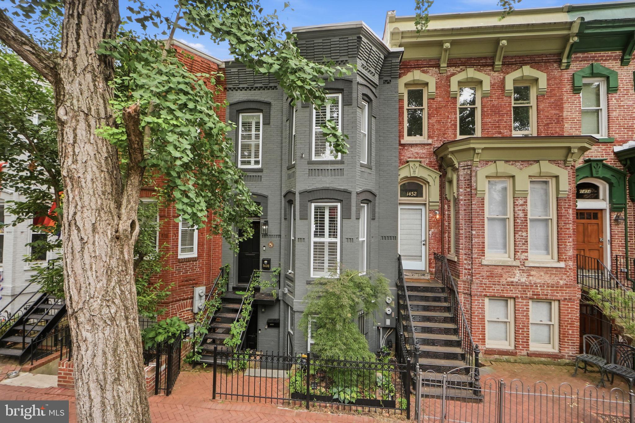 Welcome to 1430 Swann Street NW, a distinctive rowhome on one of Logan Circle’s most charming and sought-after tree-lined streets. Offering approximately 2,199 square feet, this flexible residence combines historic character, modern updates, multiple outdoor spaces, and secure off-street parking with a roll-up door.

The spacious two-level owner’s residence features an inviting living and dining area with hardwood floors, bay-front windows, a fireplace, and abundant natural light. The brand-new kitchen showcases new cabinetry, countertops, and stainless-steel appliances, creating a fresh and functional space for everyday living and entertaining.   Back door opens  to a covered rear deck, private courtyard, and secure parking area.

The upper level includes two bedrooms and two full baths. The generous primary suite features a bay window, walk-in closet, en-suite bath, and access to a private rear deck. The second bedroom is complemented by its own full bath, offering privacy for family or guests.

The separately metered English basement apartment includes one bedroom, one full bath, a full kitchen, laundry, fireplace, and private front and rear entrances. With a Certificate of Occupancy in place, this versatile space offers potential for rental income, multigenerational living, guest accommodations, or a private home office.

Ideally located near Logan Circle, Dupont Circle, and the U Street Corridor, the home is moments from acclaimed restaurants, cafés, boutiques, grocery stores, Metro, and neighborhood conveniences. A rare opportunity combining a newly renovated kitchen, flexible living arrangements, private outdoor spaces, and secure off-street parking in an exceptional central DC location.