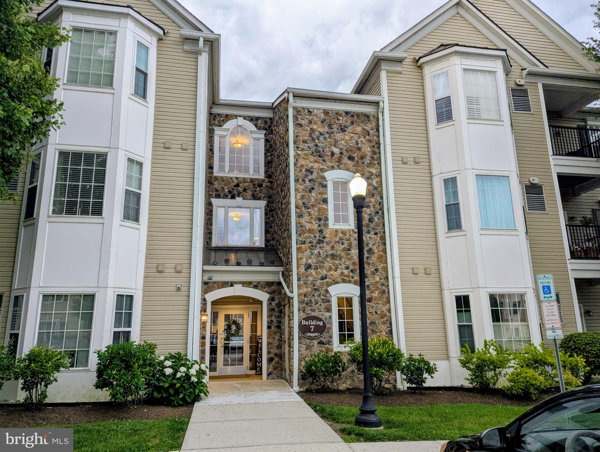 Traditions At Ridley Creek built in 2007, this condominium features an inviting open floor plan, perfect for both relaxation and entertaining.  New: heater, central air and water heater 2025, new carpet and freshly painted 2026.. Enter into the secure building with a wide hallway and elevator. The spacious living area is adorned with carpet flooring and crown moldings, creating a warm ambiance throughout. The foyer is hardwood with closet. Dining room open to the well-appointed kitchen boasts modern appliances, including a self-cleaning gas oven, built-in microwave, and dishwasher, pantry, ensuring meal prep is a breeze. Enjoy the convenience of in-unit laundry with both a washer and dryer, making everyday tasks effortless. Retreat to the primary suite, complete with a luxurious walk-in shower and ample closet space. The second bedroom is perfect for guests with a full hall bath, a Den or home office, while additional features like ceiling fans and window treatments enhance comfort and privacy. Step outside to your private balcony, where you can unwind and enjoy the tranquil surroundings, mature trees and nature. The community is thoughtfully designed with sidewalks, exterior lighting, and beautiful stone retaining walls, creating a picturesque environment. With assigned parking and easy access to nearby commuter rail stations, this community combines comfort and convenience. Enjoy the clubhouse offers a gym, library, games room and dining room with fireplace a full kitchen and outdoor seating for warm weather gatherings. Experience the perfect blend of community living and personal space in this delightful residence, where every detail has been considered for your comfort and enjoyment. Brookhaven Borough offers year round festivities including senior art and Holiday luncheon. Close drive to commuter train to Philadelphia, short drive to Media.