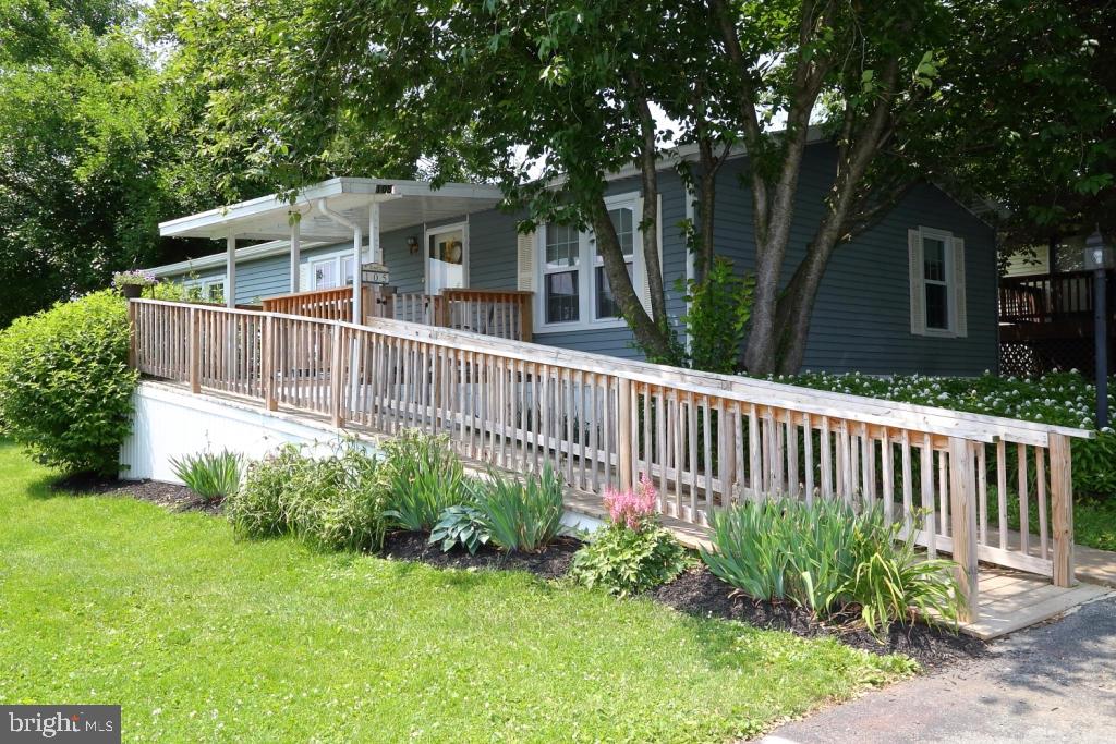 Sparkling clean, well designed, open floor plan. Pretty, artistic decor. Lots of light. Enjoy relaxing on the porch overlooking the manicured lot. Affordable living to fulfill your needs.Fee includes cable, trash and community amenities. Fireplace is electric. Shed stays in present condition.