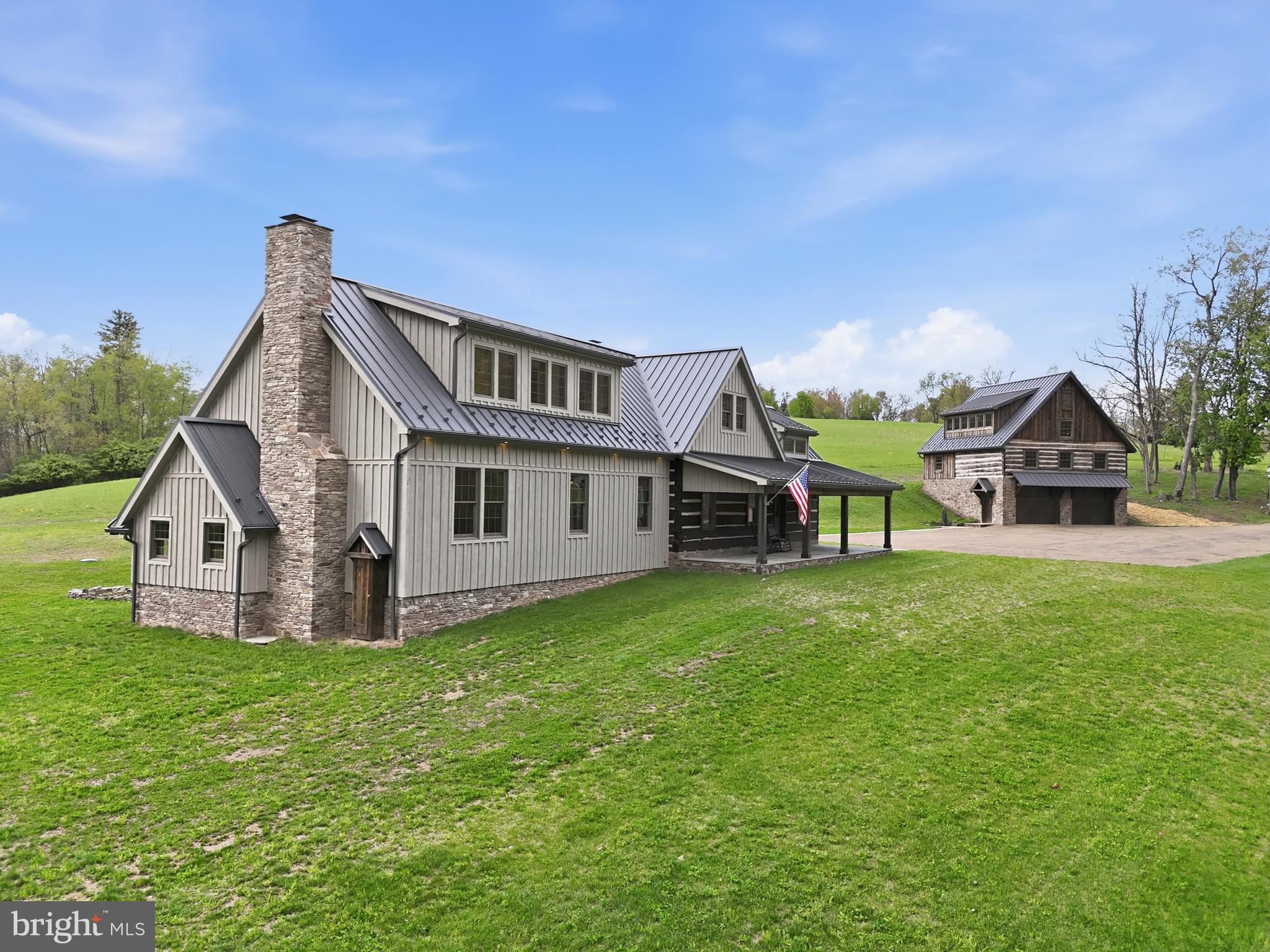 Step into a rare piece of Lycoming County history with this beautifully restored pioneer log home dating back to the 1780s. Thoughtfully reconstructed, the original structure was carefully dismantled, preserved, and reborn. Featuring original floors, hand-hewn trusses, and a stunning summer beam that anchors the great room. Fireplaces showcase stone sourced directly from the property, including a mantle crafted from the original cornerstone. Every detail reflects true craftsmanship, with kiln-dried, hand-sanded, and beaded wood throughout. The impressive bank barn mirrors this quality, incorporating reclaimed materials from a historic hemlock cabin from Beech Creek. Set on 7.13 scenic acres in the Ravenwood Development, Loyalsock Township. This 4 bedroom, 4 bath home offers modern comfort with timeless character. Enjoy a luxurious primary suite with a handcrafted fireplace, walk-in closet and full bath with marble floors. Adding even more versatility and charm, the exceptional bank barn features a beautifully finished upper level. Perfect for entertaining, a studio, or additional living space while the lower level offers a spacious two car garage for everyday convenience. The property is thoughtfully equipped for comfort and peace of mind with two wells, a whole-house generator, and a dual heating system paired with central air conditioning to ensure efficiency year round. An outdoor summer kitchen with propane adds both function and character, creating the perfect setting for gatherings, picnics or simply enjoying the historic feel of this remarkable property. Every inch of this estate has been carefully designed to blend early American heritage with modern-day livability, making it truly one of a kind.