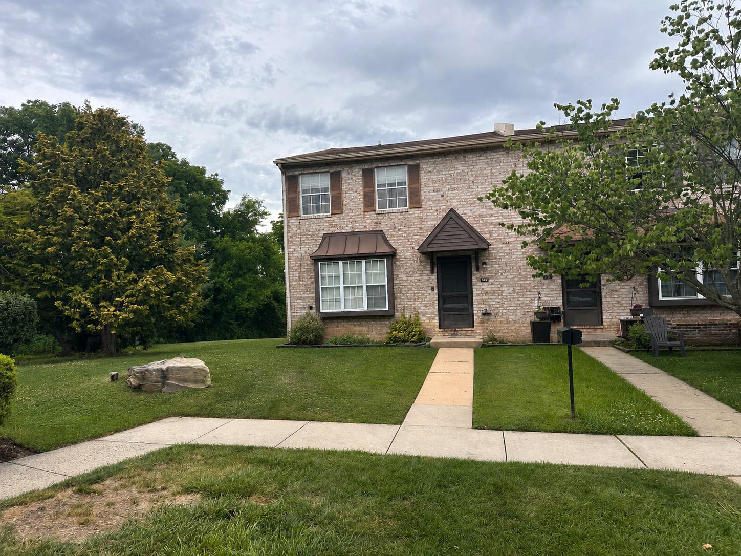Welcome to this end-unit townhome with walk out basement in the desirable Rhondda community, offering a great opportunity to personalize a home in an exceptional location. Situated in the award-winning Downingtown Area School District and conveniently located near shopping, dining, parks, and major commuter routes, this home combines value, space, and potential. The main level features a spacious living room, a convenient powder room, and an eat-in kitchen. The washer and dryer are located in the kitchen, providing first-floor laundry convenience. Sliding door leads to the rear deck with an expansive view of the common area.Upstairs, you'll find a primary bedroom with a private bath, along with two additional bedrooms and a full hall bath. The home retains its original kitchen, bathrooms, and flooring, providing an excellent opportunity for a new owner to update and renovate to their own taste. The full walk-out basement offers outstanding storage space and the potential for future finished living space. Two assigned parking spaces are located directly in front of the home.  Residents of Rhondda enjoy a wide variety of community amenities, including a swimming pool, tennis and pickleball courts, basketball court, walking trails, playgrounds, and the ability to have a fence.  HOA fees are low. Conveniently located just minutes from Routes 100, 202, the Pennsylvania Turnpike, Main Street at Exton, shopping, restaurants, and major employers, this home is also within the Downingtown East High School attendance area, home to the nationally recognized STEM Academy.  Whether you're a first-time buyer, investor, or someone looking for a home you can update over time, this end-unit offers a rare opportunity to build equity in one of Exton's most popular communities. Home is being sold as-is. Buyer will take responsibility for items left behind.