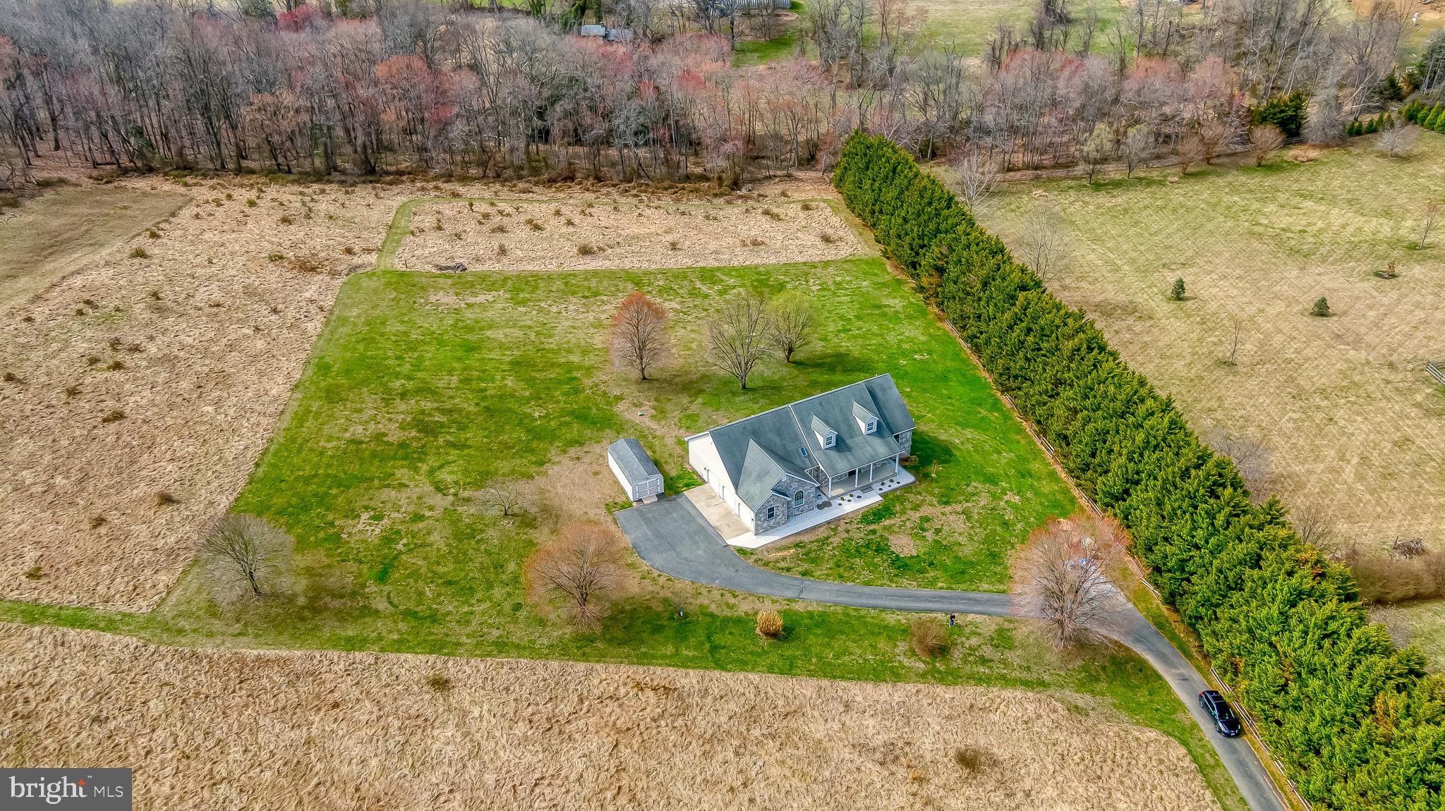 Must See!  This stunning custom-built stone rancher with a three-car garage showcases exceptional craftsmanship, luxury finishes, and meticulous attention to detail throughout. Completely refreshed with extensive high-end upgrades, this home offers the perfect blend of timeless design and modern convenience. The fully renovated chef’s kitchen (2025) features premium GE Monogram appliances, elegant quartzite countertops, and an impressive 10-foot prep island, creating a beautiful and highly functional space for cooking and entertaining. Throughout the home you’ll find all-new ¾-inch solid oak hardwood flooring (2025) along with updated lighting and fresh paint (2025) that add warmth and sophistication to every room. Major mechanical updates include a new HVAC system (2024) featuring an energy-efficient Bosch heat pump with backup propane furnace, providing year-round comfort and efficiency. The hall bathroom and laundry room were tastefully updated in 2024, complemented by new washer and dryer for added convenience. Step outside to enjoy thoughtfully designed exterior improvements including a new concrete sidewalk, retaining wall, and low-maintenance landscaping, all leading to a beautiful patio retreat surrounded by peaceful wooded views and expansive open space—an ideal setting for relaxing or entertaining outdoors. With countless upgrades, luxurious finishes, and a tranquil setting, this exceptional home truly offers move-in ready living at its finest.