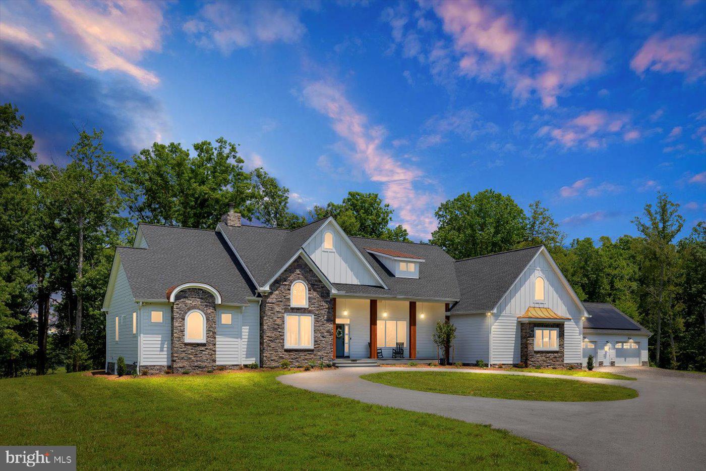 Welcome to this exquisitely designed waterfront retreat—an extraordinary blend of luxury, craftsmanship, and serene living, nestled on a sprawling 7.59-acre lot in the prestigious Fortunes Landing community.
This 4,327 sq ft custom-built home invites you in with breathtaking views of the water, framed by expansive windows that line the entire rear of the home. From the moment you step inside, the sense of space, light, and elegance is undeniable. Gourmet Kitchen, a chef’s dream featuring double oversized quartz islands, a 6-burner gas cooktop with pot filler, farmhouse sink, two dishwashers, stainless steel appliances, and a stone accent wall with floating shelves. Exposed wood beams and 10-foot ceilings add rustic charm.
Family room with soaring 12-foot ceilings, a cozy stone gas fireplace, and folding glass doors that open to a covered porch and expansive deck—perfect for indoor-outdoor living. A private Study with vaulted ceilings, wainscoting, and a hidden vault door leading to a storm-safe closet. The Primary Suite, a true sanctuary with 12-foot coffered ceilings, lake views, custom built-ins with a rolling library ladder, cozy window seats with storage, his-and-hers closets, and a private laundry area. The spa-like en suite bathroom includes a soaking tub, massive tiled shower, and double vanities.
Three additional bedrooms, including a guest suite with private bath and two bedrooms connected by a Jack-and-Jill bath. Upstairs, enjoy a flexible bonus space perfect for a playroom, art studio, and a home gym or additional bedroom with a half bath. A mudroom with built-in lockers, washer & dryer, sink, and walk-in shower—ideal for pet grooming or post-outdoor cleanup.
Outdoor living & entertaining features a covered porch & deck, equipped with a built-in grill, range hood, sink, and pass-through windows for effortless entertaining.
The pool house is about 793 sq ft, featuring  a kitchen, half bath, and lounge on the main level with a roll-up glass garage door overlooking the lake. Upstairs includes a bedroom, full bath, balcony, and storage for pool essentials.  Oversized attached, side-load 2-car garage with additional entry. Additionally a detached garage complex offering, an oversized  2-car garage with 14-foot doors—perfect for storing large equipment or recreational vehicles, solar panels, with a dedicated utility room for future pool needs. A heated and cooled workshop, that can be converted to make this a 3car detached garage.
This home is not just a residence—it’s a lifestyle. With thoughtful design, luxurious features, and endless possibilities for relaxation, recreation, and entertaining, this one-of-a-kind property is ready to welcome you home.  This secluded community is situated along the Ni River Reservoir, providing residents a range of activities, whether you're walking, biking, canoeing or kayaking, Fortunes Landing has plenty for all.