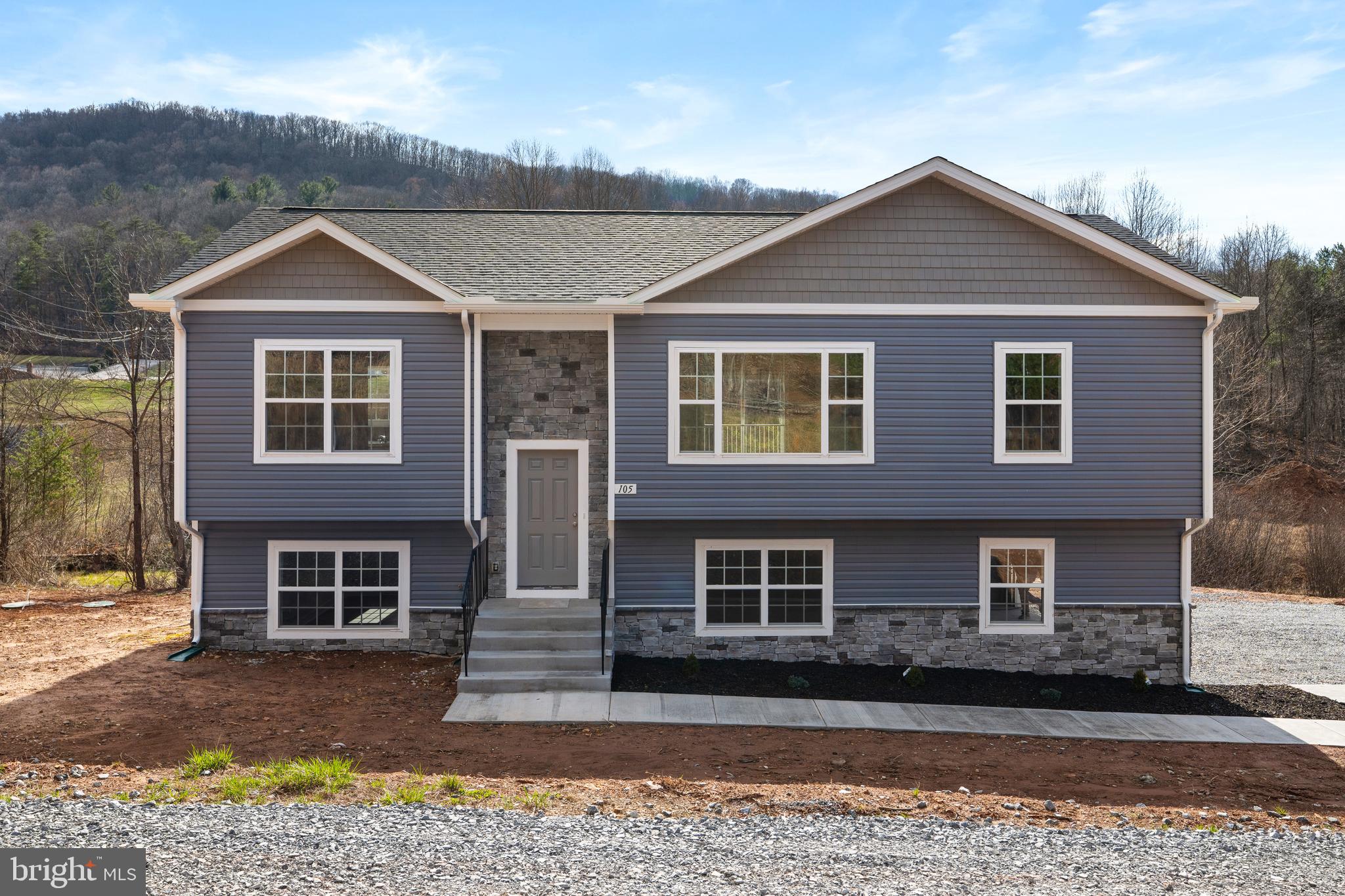 Welcome to 105 Victory Ln, a brand-new construction home on 2.5 acres with no HOA, offering space, freedom, and serious value in Hedgesville, WV. Built in 2026, this 3-bedroom, 2 full and 1 half bath split foyer is completely move-in ready with nothing to worry about. The layout is functional and open, with a spacious main level that flows right into a standout kitchen featuring granite countertops, stainless steel appliances, a large pantry, tons of cabinetry, and even a dedicated coffee bar area. The primary suite is generously sized and includes a private bathroom with a corner soaking tub, dual vanities, and a tile walk-in shower, and every bedroom comes equipped with ceiling fans. The finished lower level offers a large recreation room that works perfectly as a second living space, office, or hangout area, along with a deep two-car garage and an expansive driveway with plenty of parking. LVP flooring runs throughout both the main and lower levels, with carpet in the bedrooms for added comfort. Tucked into a peaceful country setting while still being just minutes from I-81, this location gives you the best of both worlds. Homes with this kind of acreage, no HOA, and new construction at this price point don’t come around often. This one is truly one of a kind!