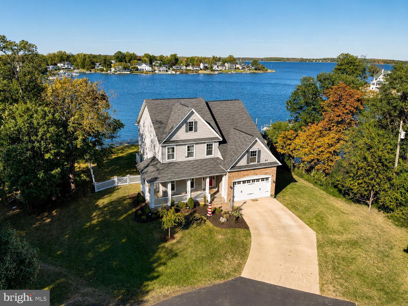 OPEN HOUSE Sunday July 12 from 10-12n!!!   This remarkable 2+ acre waterfront estate spans two lots with separate tax IDs, offering 560 feet of protected shoreline and stunning 180-degree views over Ramsey Bay to the South River. Surrounded by natural beauty and privacy, the shoreline is reinforced with underwater riprap for lasting stability. The 3,500-square-foot home includes 4 bedrooms, 3.5 baths, rich hardwood floors, a striking stone fireplace, and a gourmet kitchen with high-end finishes. The owner’s suite boasts sweeping water views, while the outdoor spaces feature two spacious waterfront decks and a deep-water private pier with boat lift—ideal for enjoying the Chesapeake lifestyle. An exceptional property not to be missed.