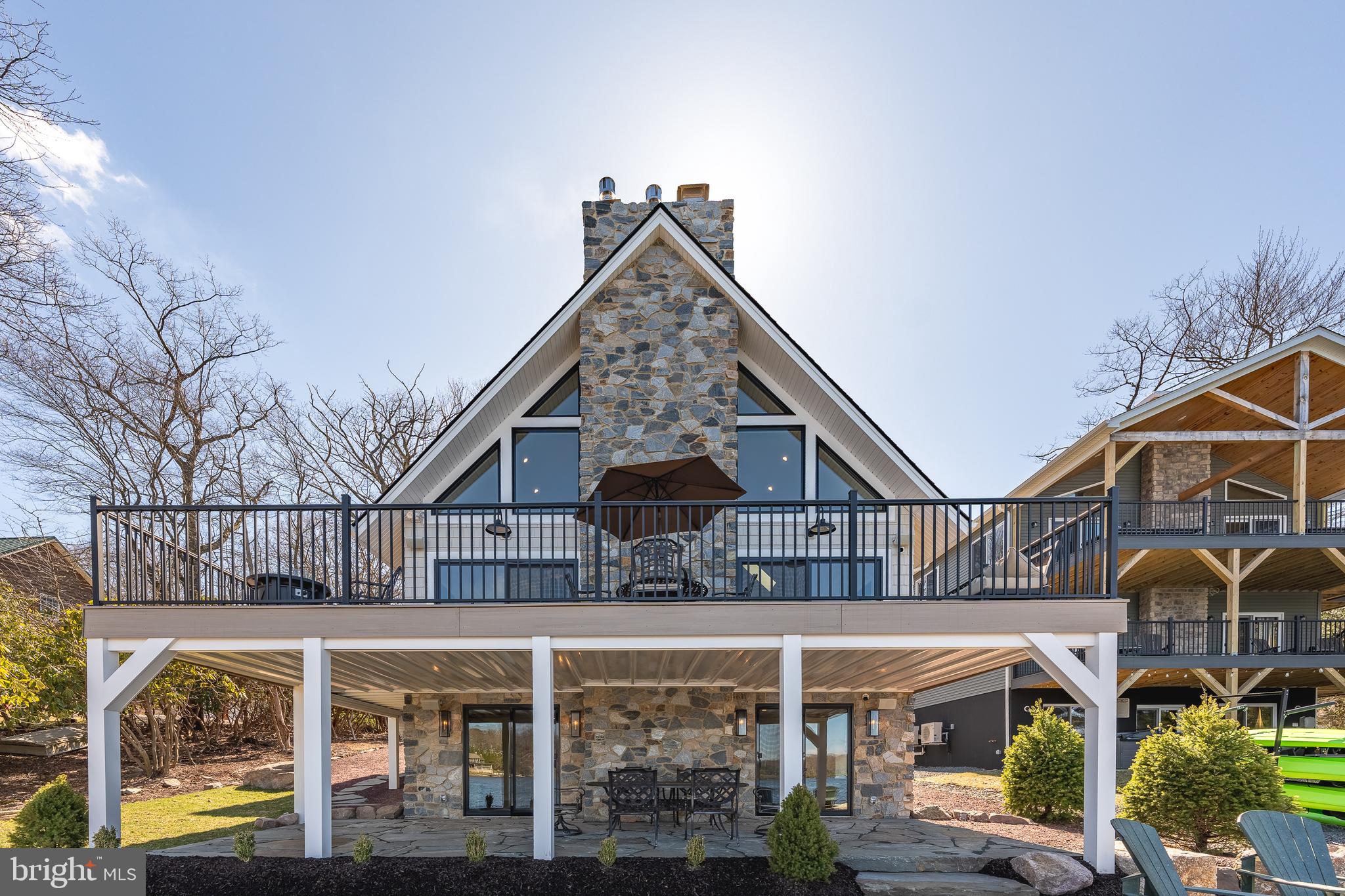 Welcome to breathtaking, fully furnished tranquility on Lake Harmony. 138 South Lake Drive is truly the rare opportunity to park, open the front door, and enjoy 2024 on the water. Completely reconstructed, reimagined, and redesigned by award-winning Stonewood Interiors.  This three-level 3250 SF masterpiece sleeps 12, has 3 full bathrooms, parking for 6 vehicles, a redesigned 2-car garage, and two expansive levels of outdoor space only 15 steps to the water's edge.  Exquisite finishes throughout including a soaring 2 story family room with views of the lake, chef's kitchen, spa, bathrooms, state-of-the-art mechanical security systems, and a lower level perfectly created for entertaining or as a kid's paradise.  Prominently located on the south shore of Lake Harmony with arguably the finest view of the lake, this unique property is being sold including all fixtures, furnishings, and systems.