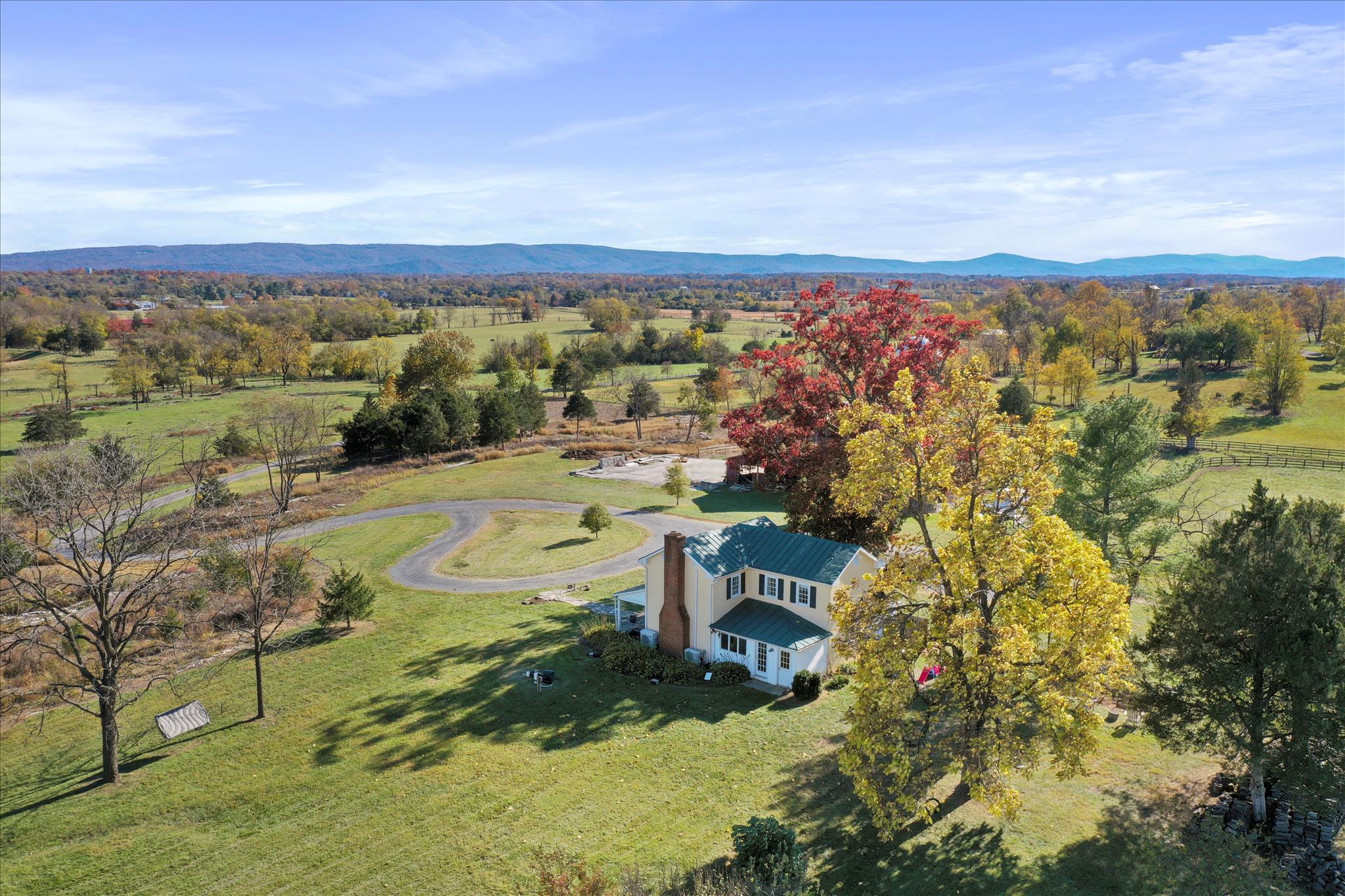 In real estate, it's all about location. This isn't just a location — it's a high-cation. Opportunities like this are exceedingly rare: surrounded by large, protected parcels — many in conservation easement — in the heart of Hunt Country, under $1M, and an hour to Washington, D.C. This is the unicorn, offering a truly uncommon chance to embrace peaceful, abundant country living without compromise.

Awaiting its next stewards, this picture-perfect vintage farmhouse is beautifully sited on 15.9 acres in coveted Blue Ridge Hunt territory, where a constant breeze and soft eastern mountain views set the rhythm of daily life. A winding half-mile drive sets the tone, leading to a storybook setting where historic charm meets modern ease.

Inside, the 1,732 sq ft home is warm and complete — original hardwood floors, custom built-ins, and a wood-burning fireplace create an inviting atmosphere that is immediately livable. Three well-appointed bedrooms feature tailored storage, while a dedicated home office, laundry/mudroom with utility sink, and a private outdoor shower add thoughtful functionality. Every room is framed by picturesque views of the surrounding landscape.

Outdoors, the property is equally compelling. A historic 60x40 two-story oak barn with electricity offers three stalls, a workshop, and a hay loft of extraordinary scale — a historical structure that defines the character of the entire property. A 40x100 metal equipment shed with concrete flooring provides serious working infrastructure. Additional outbuildings include a smaller ruminant barn and repurposed grain silos reimagined as charming chicken houses — blending practicality with a touch of whimsy.

During their time here, the current owners have thoughtfully shaped the land for both beauty and utility — clearing acreage for pasture, adding extensive fencing, and creating a productive vegetable garden alongside a Virginia native flower garden and a dedicated cut flower garden. The groundwork is in place for small-scale animal husbandry and a true farm-to-table lifestyle. It's a property that invites you to live off the land, surrounded by character and authenticity that typically commands a far higher price point.

Ideally located just 6 miles to Berryville, 8 miles to Winchester, and just 20 minutes to Middleburg, this offering strikes a rare balance — peaceful, private, and beautifully connected.
