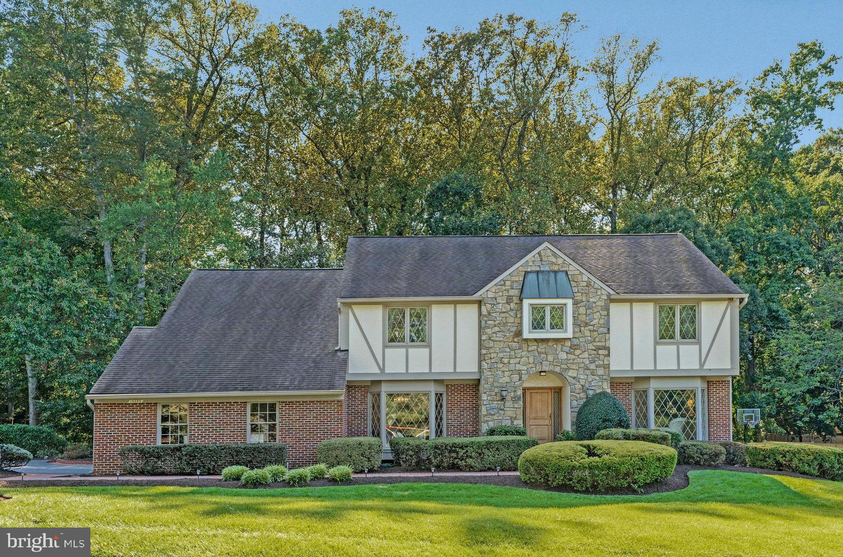Welcome to 10309 Hickory Forest Drive -  an enchanting, one owner,  storybook Tudor style home in Hickory Hollow Forest, an enclave of 21 custom homes in the heart of Oakton. This exceptional home, thoughtfully designed, features four large bedrooms on the upper level, with an option for a fifth bedroom, four bathrooms, three gas fireplaces, hardwood floors, Plantation shutters,  a lovely screened in porch, multilevel composite decks, underground irrigation system,  Cul de sac lot  and so much more. Prepare to be impressed with this beautiful estate, offering timeless sophistication,  sited perfectly on a park-like .60 acre lot with extensive professional landscaping. With impressive curb appeal, the home features a brick walkway to the front porch and gorgeous hardwood door with leaded glass opening to the spacious and welcoming foyer which leads to an inviting floor plan with both formal and informal spaces. This meticulously maintained home offers exceptional craftsmanship and only the finest quality finishes throughout. Boasting more than 5700 sf of functional living space and a thoughtful, custom design, this home was made for gathering and entertaining with a lovely custom kitchen that opens to an impressive screened in porch with beautiful cherry hardwood floors, a multi level composite deck with stairs to the lower level patio, all with views of the unbridled beauty of the fully fenced rear yard. A true private oasis. 

 From the kitchen, enter the great room with 9 foot ceilings and a grand stone gas fireplace, large dramatic windows and wonderful views of nature. A formal living room and dining room are adjacent the large foyer. Perfect for entertaining. The site line from the foyer to the great room is a fabulous view directly to the stone fireplace. WOW!  A main level study/library, masterfully crafted, featuring custom built-in cabinetry, is perfectly tucked away in the rear corner of the home with a  large bay window overlooking the lovely rear yard. An ideal space to work, read, or simply relax. Finishing up the main level is the laundry/mud room with built in cabinetry and doors leading to the oversized two car garage and the  side portico leading out to the rear deck and driveway.  The attention to detail is unsurpassed with custom finishes throughout, upgraded hardware on doors and cabinets, hand crafted built-ins, hardwoods on main level, a lovely kitchen and 4 beautiful bathrooms. The expansive, luxury primary suite is truly luxurious featuring a gas fireplace, a sitting room and a spa-inspired, renovated primary bathroom complete with dual sinks, walk in shower, soaking tub and walk in closet. Three additional, generous sized bedrooms are on the upper level, a sitting area/reading nook and a hall bathroom.

The finished lower level is truly an extension of the home with a warm and welcoming family room with a third gas fireplace, custom built in bar and sliding glass doors to the lower level patio. The walk- out lower level also offers a game room with pool table which conveys, an exercise room, full bathroom with sauna and large utility/storage room. 

The parklike setting is a dream year round with lush, manicured gardens, shrubs and trees and walking paths through the yard. Enjoy entertaining on the deck, or a quiet evening on the patio watching nature unfold. 

 Public water and sewer are a bonus and allow for the potential to add a pool. 

Desirable Oakton Elementary, Thoreau Middle, Oakton High School pyramid. Minutes from the Oakton Shopping Center with Starbucks, CVS and Giant, and quick access to major commuter routes - 66, 495 and the Toll Road, 3 miles to the Vienna Orange Line Metro.