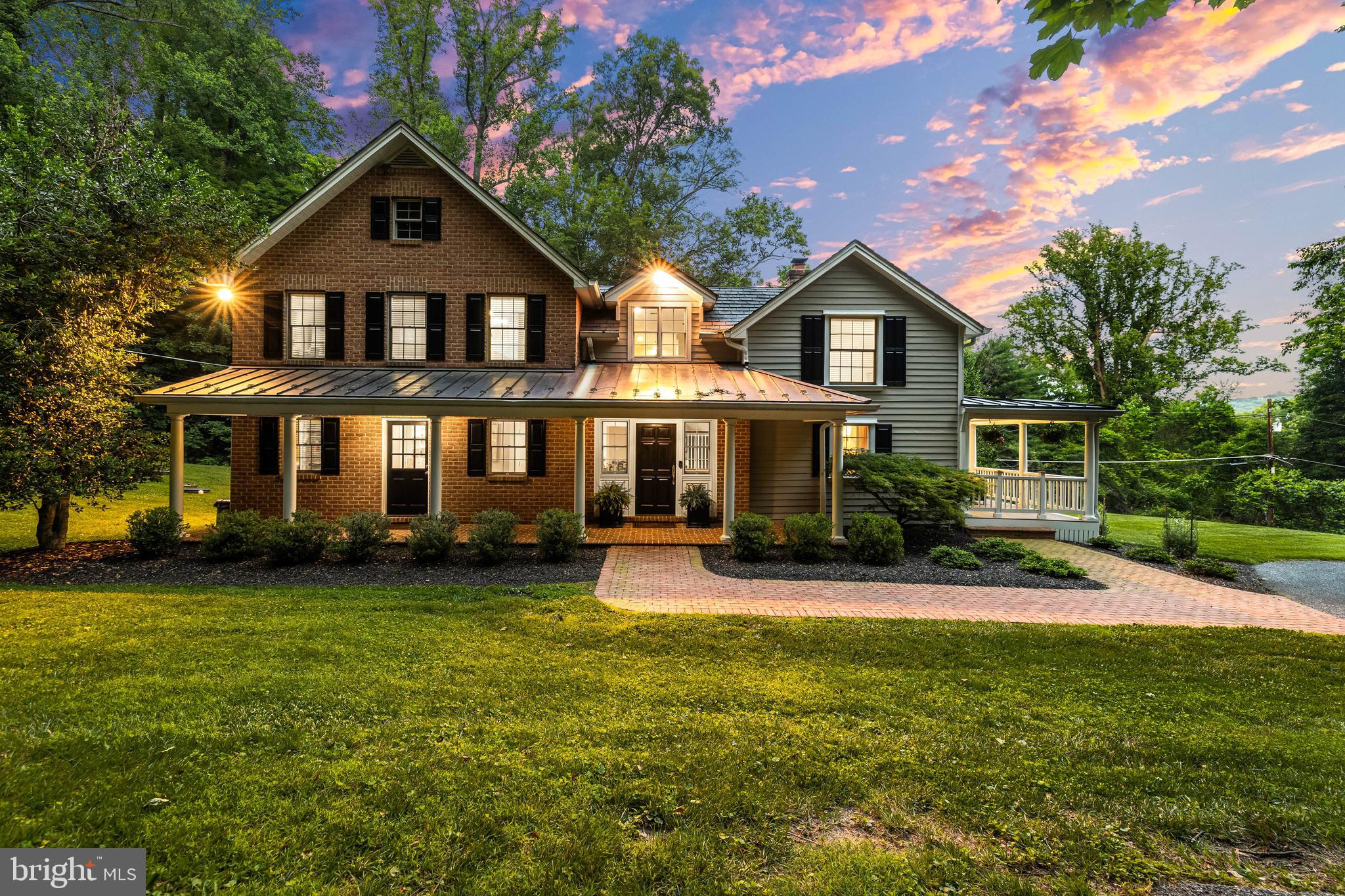 Nestled in the highly coveted rolling hills of Greenspring Valley, 2628 Greenspring Valley Road presents a timeless sanctuary of charm and sophistication on a serene 0.6-acre lot. This distinguished residence seamlessly blends classic elegance with thoughtful modern updates, offering an unparalleled private retreat in one of Maryland’s most sought-after enclaves, adjacent to the prestigious Greenspring Valley Country Club and moments from Baltimore’s vibrant cultural scene.
The home’s crowning outdoor feature is its expansive wraparound porch, an impressive 40 by 38 feet, meticulously rebuilt in 2019 with new flooring and complemented by fresh paint on shutters and siding in 2022. Surrounded by mature landscaping enhanced through 2017–2024, this gracious space invites morning coffees with dappled sunlight filtering through the trees or evening gatherings overlooking the valley’s gentle slopes, ideal for al fresco entertaining or quiet contemplation amid nature’s embrace.
Step inside to a spacious main level boasting exceptional flow and versatility, where sun-drenched rooms transition effortlessly between intimate family living and sophisticated entertaining. Generous windows flood the interiors with natural light, highlighting an open, airy layout anchored by two cozy fireplaces - one in the inviting family room and another in the formal living area. Stylish updates, including fresh paint (2017) and contemporary kitchen appliances (2024 dishwasher and microwave), elevate everyday living and effortless hosting.
Upstairs, four generously proportioned bedrooms await, highlighted by a primary suite with a spa-like bath and supported by three additional full baths (plus a powder room). Recent improvements, such as a new water softening system (2022), updated chimneys (2017), and a new well water tank (2019), ensure modern comfort and peace of mind throughout.
Adding to the home’s tremendous potential is a nearly 1,500-square-foot unfinished walkout lower level. With direct outdoor access, this expansive space can be easily finished to create additional living areas, a recreation room, home theater, guest suite, or whatever vision suits your lifestyle, further enhancing the home’s already substantial 3,556 square feet of finished living space.
This Greenspring Valley gem is more than a residence; it is a refined canvas for cherished memories, where privacy, natural beauty, and timeless elegance converge in perfect harmony.