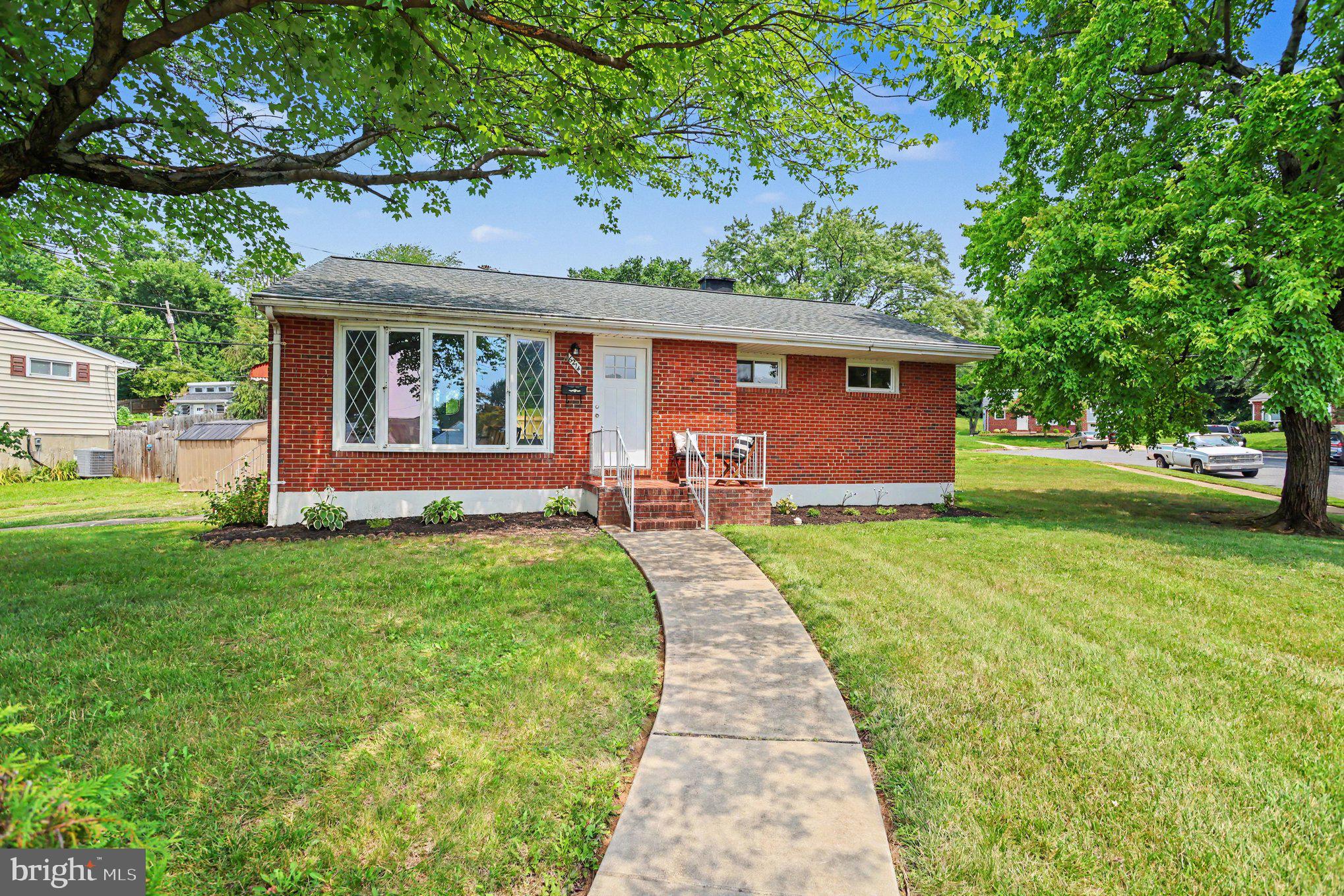 Welcome home to this beautifully updated all-brick rancher situated on a desirable corner lot. Offering three spacious bedrooms plus a versatile den/bedroom in the lower level and two full bathrooms, this home combines timeless charm with modern updates.

The bright, sun-filled living room welcomes you with abundant natural light, while the updated kitchen features beautiful quartz countertops, and brand-new stainless steel appliances. Both bathrooms have been tastefully renovated, and the home boasts freshly refinished hardwood floors and fresh paint throughout, creating a truly move-in-ready interior.

Additional updates include a new roof (2023), newer water heater, new kitchen stainless steel appliances, and an HVAC compressor and inside coil in 2025, providing peace of mind for years to come.

The finished lower level offers exceptional flexibility with a spacious club room complete with a built-in bar, a full bathroom, and an additional room that is perfect as a fourth bedroom, home office, den, or fitness room.

Set on a desirable corner lot, this classic all-brick home offers the perfect blend of character, quality construction, and modern convenience.