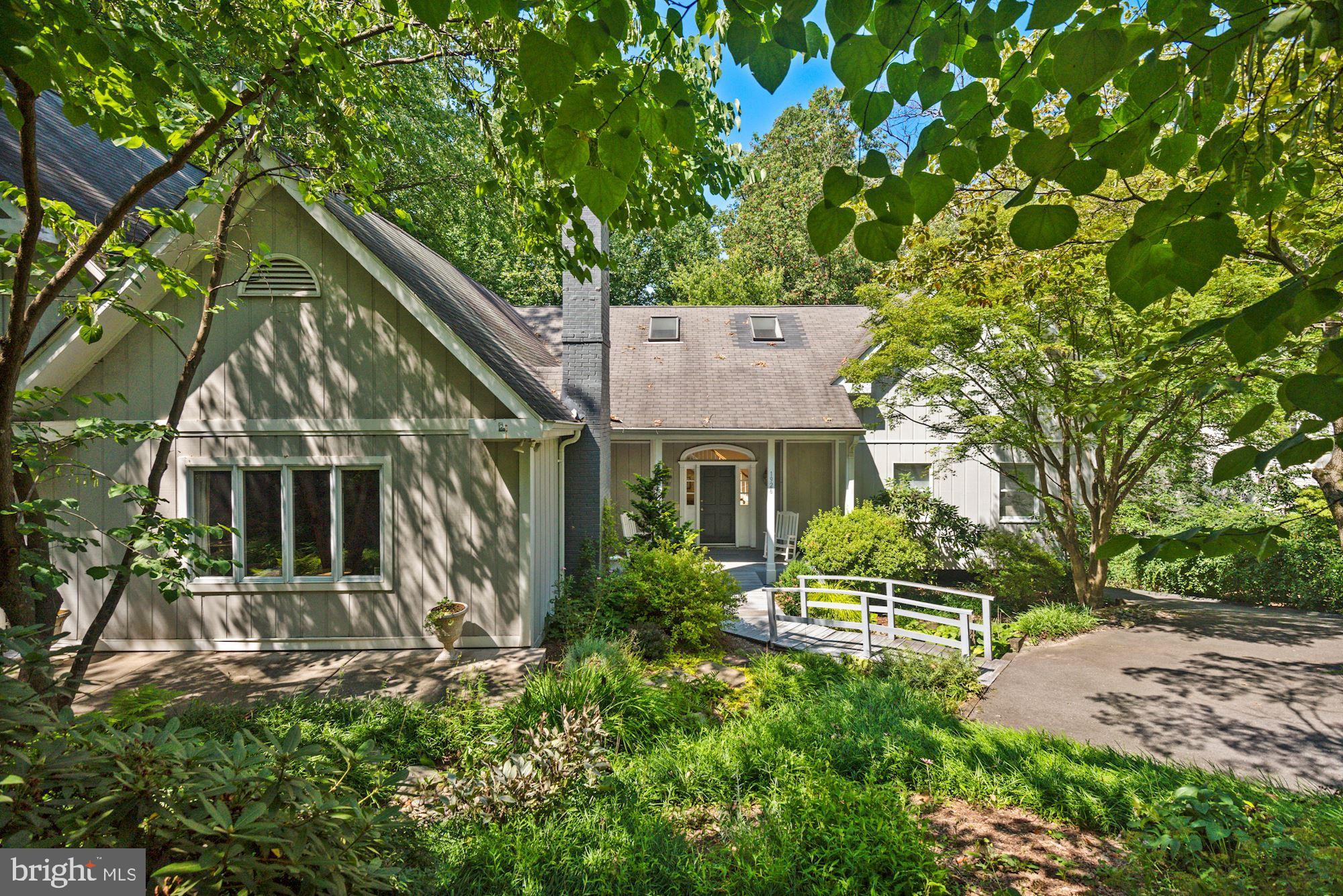 Amidst Franklin Park's winding wooded lanes, this home is nestled on a  private 1/2 acre lot with serene views. Generous windows bring in an extra dose of sunshine to approx. 4912  interior SF.  Architectural elements like vaulted ceilings, stone accents and loft spaces, paired with a comfortable open flow, make this home truly unique. A  kitchen with vaulted ceiling flows into breakfast area, family room with stone fireplace, living room and dining room. The upper bedroom wing connects to an upper loft/office and the two-story primary bedroom suite with loft is accessed on the ground level. On the upper level, the secondary bedroom wing connects to a bonus loft office/den. The home features multiple outdoor spaces, including front patios, two bedroom balconies and a three level deck. Front landscaping, large driveway, daylight basement (w/ kitchenette) and 2 car garage.
 
Sited beautifully in the sought-after community of Franklin Park, known for its lush natural landscape, mature trees, and charming rolling hills, this home offers access to the best of McLean with its close proximity to all that Downtown McLean has to offer, and is also ideally situated just minutes to the George Washington Parkway, 1-66, Tyson’s Corner, and the Capitol Beltway.