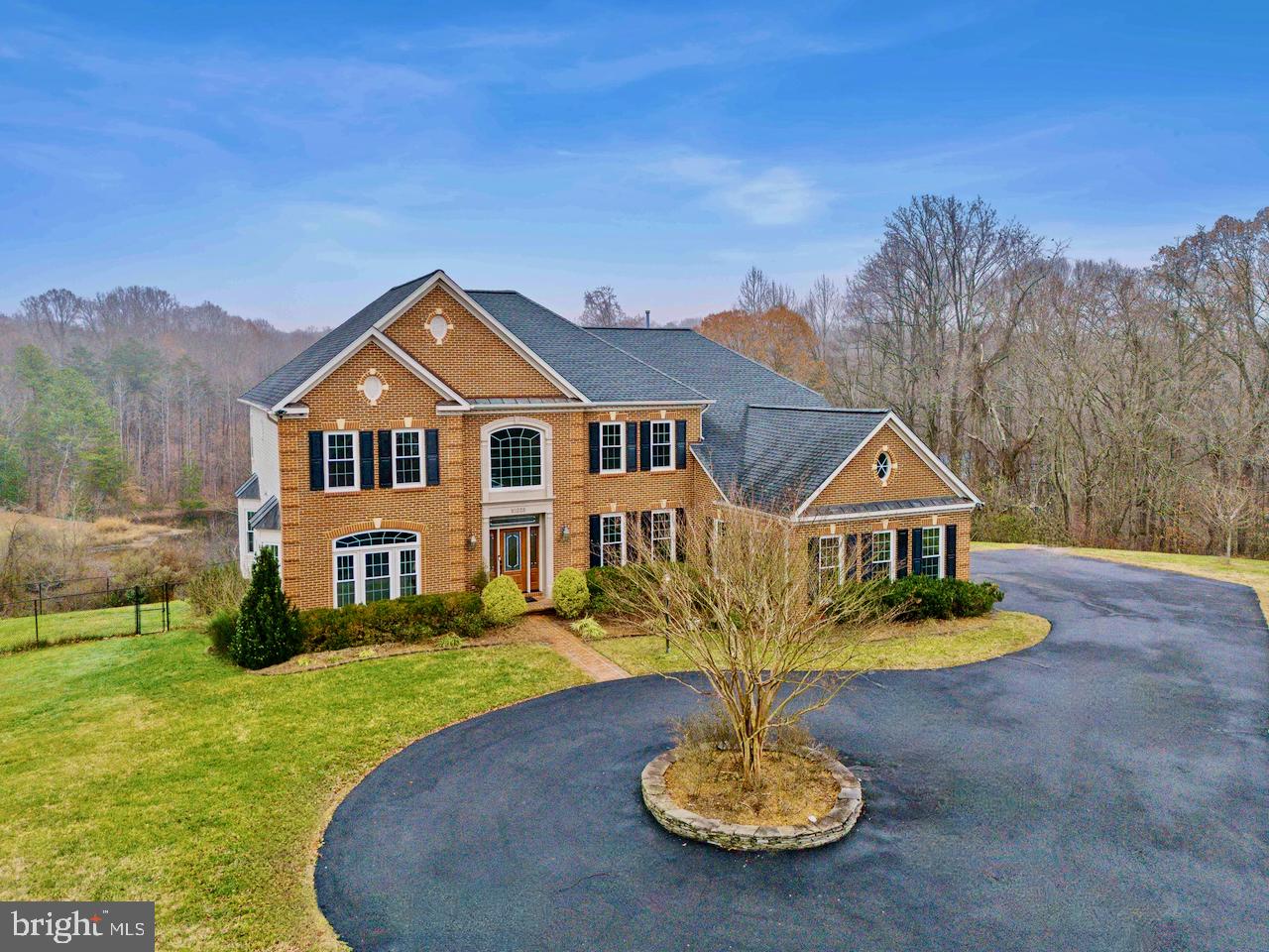 Your private sanctuary awaits! Welcome to Van Thompson, an unparalleled retreat, nestled within the idyllic embrace of Fairfax Station. Set on a picturesque 5-acre lot graced by tranquil pond views, this estate is a true embodiment of luxury and serenity. Offering nearly 6,500 square feet of meticulously designed living space, this five-bedroom, five-bathroom residence captures the essence of refined living. 

 An impressive arrival as you approach this beautiful home, welcomed by a circular driveway to the three-car garage. Step through the main entrance into a breathtaking two-story foyer, where marble floors and a sweeping curved staircases make an unforgettable first impression. Oversized windows bathe the interior in natural light, highlighting gleaming hardwood floors and stunning views of the lush grounds. 

Elegance meets everyday living at Van Thompson. The main level is a harmonious balance of grandeur and comfort. Entertain effortlessly in the formal sitting and dining rooms or retreat to the private home office. The gourmet kitchen is a chef’s dream, featuring stainless steel appliances, 42” maple cabinetry, granite counter tops, under cabinet lighting, and plenty of prep & storing space.  The kitchen extends into the spacious breakfast room and inviting sitting area connected by a gas fireplace and picturesque views of the grounds. From here, step out onto the expansive deck, perfectly positioned for al fresco dining and unwinding amidst nature.

A secondary family staircase provides seamless access to the upper level, where the luxurious primary suite awaits. This serene sanctuary features plush carpeting, tray ceilings, a cozy sitting area, and dual walk-in closets linked by an elegant dressing area. The spa-inspired en-suite boasts separate vanities, a soaking tub, a walk-in shower, and a private water closet.  The upper level additionally features three spacious secondary bedrooms, one en-suite full bathroom, and a split jack/jill bathroom with separate en-suite vanity spaces.
Endless possibilities await as we head into the lower level of this exquisite estate. A true walk-out basement featuring living spaces filled with natural light pouring through the many full-sized windows and doors.  Catering to every entertainer’s dream with thoughtful design and features like new plush carpets, custom home theater with custom oak built-ins, a wet-bar with full sized fridge and granite counters, game room, and enormous recreation room. A private guest suite with a full bathroom ensures flexibility for family, visitors, in-laws or a nanny!

Unmatched tranquility embracing convenience as Van Thompson offers unparalleled privacy while remaining just moments from premier shopping and dining. Whether you’re hosting grand celebrations on the expansive deck, paver patios, screen-in porch or savoring quiet moments by the pond or in the woods, there is no question these perfectly positioned 5-acres can’t be your retreat from the chaos of city life. Enjoy idyllic walks down Van Thompson Road leading you straight to the Occuquan Reservoir – the excitement in having Sandy Run Regional Park in your backyard! 10235 Van Thompson Road is more than a home—it’s a lifestyle. Your secluded oasis is ready to welcome you. Schedule a private tour today.