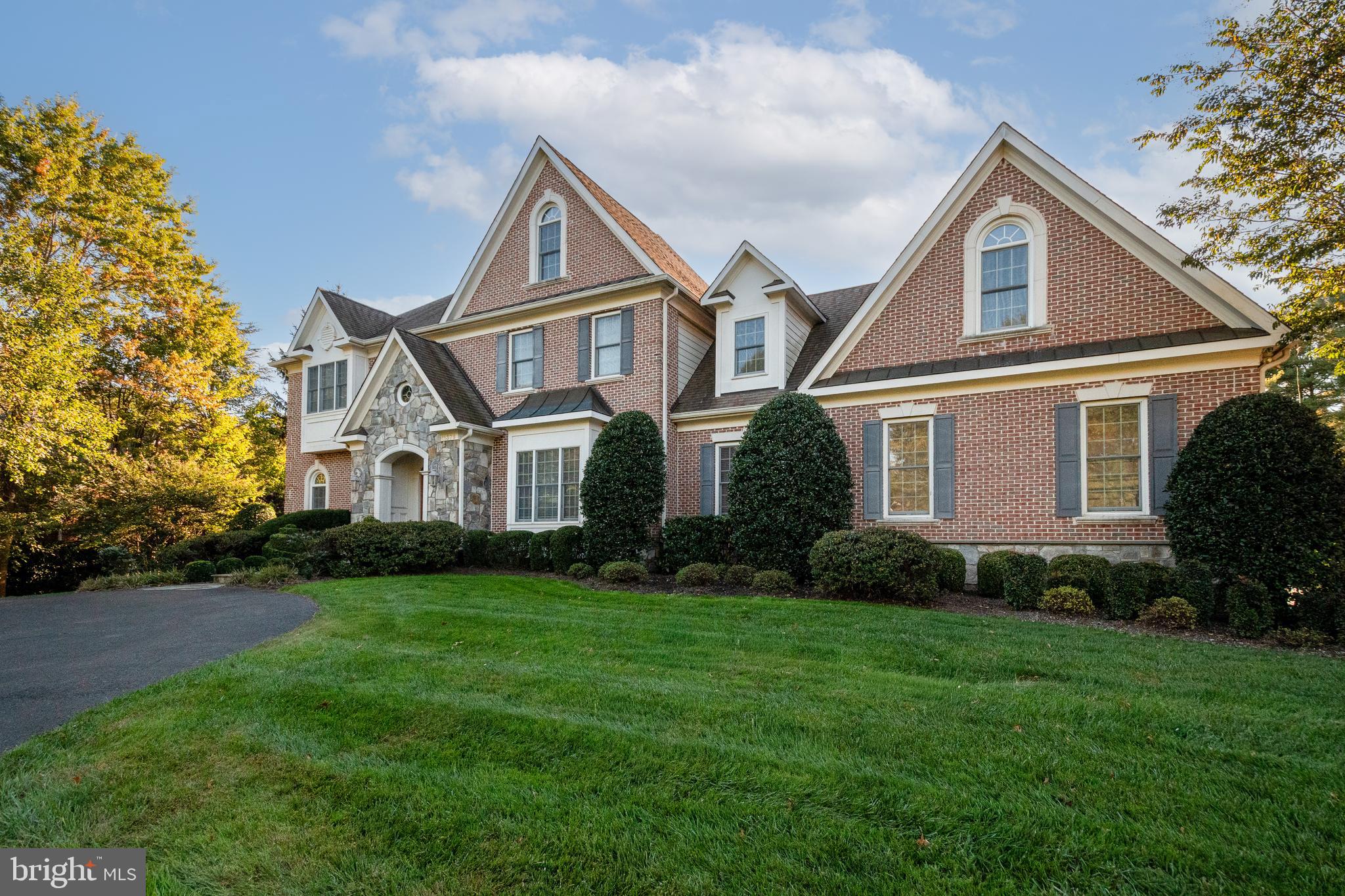 PRICE IMPROVED AND READY FOR YOU! Discover the perfect blend of luxury and privacy in this stunning 7,000+ square foot brick and stone home nestled on a sprawling 1.8-acre fenced lot with mature landscaping in a quiet neighborhood. The possibilities are endless across three finished levels, featuring 5 bedrooms, 4 full baths, and 2 half baths. Custom Built by Foley Construction in 2006, this architectural gem greets you with a grand circular driveway and an oversized three-car garage. Step inside the two story foyer with grand staircase to find soaring 10-foot ceilings and gleaming hardwoods throughout the main level, with elegant formal living and dining rooms off the foyer. The main level features a chef’s kitchen with 13-foot ceilings, top-of-the-line appliances, durable ceramic tile, and a cozy morning room leading to a large sun-drenched family room with stone fireplace, making this space the heart of the home. This level also features custom touches such as a large home office with built-in shelving, custom built-in storage bench and lockers in the mudroom, butler’s pantry with custom cabinets, and a large brick patio overlooking a beautiful treed yard.

The second level houses a luxurious primary suite framed by large windows, which includes a spacious spa-like bathroom and two large walk-in closets. It also houses a convenient laundry room with commercial washer. Three other bedrooms, one with an en-suite bathroom and the other two with a shared bath, complete the second level. A curved open staircase leads to a finished walk-out lower level that is a true destination for entertainment and relaxation, boasting a full wet-bar (with sink, full sized refrigerator, and dishwasher), a dedicated workout room, a large recreation room with a stone fireplace, a billiard area (with pool table that stays for your first tournament), and a guest bedroom with a full bathroom. Outside you will find a lush, fully fenced-in yard enveloped by mature trees and landscaping that provides a peaceful and private sanctuary for play or simply enjoying nature. Whether you’re entertaining or enjoying a quiet night with family and friends, this home offers the perfect blend of space, privacy, nature, and custom finishes.

In addition to its custom craftsmanship, this home has been meticulously updated and maintained, including: new HVAC for all three floors (2018); fresh exterior paint (2026); comprehensive professional interior paint refresh (2026 & 2023); wall oven and microwave (2024); second floor carpeting (2021); main level recreation room hardwood floors (2021); work-out room flooring (2021); LED under-counter kitchen lights (2026); and well system (exterior well casing (2026); pump and controller (2016)).