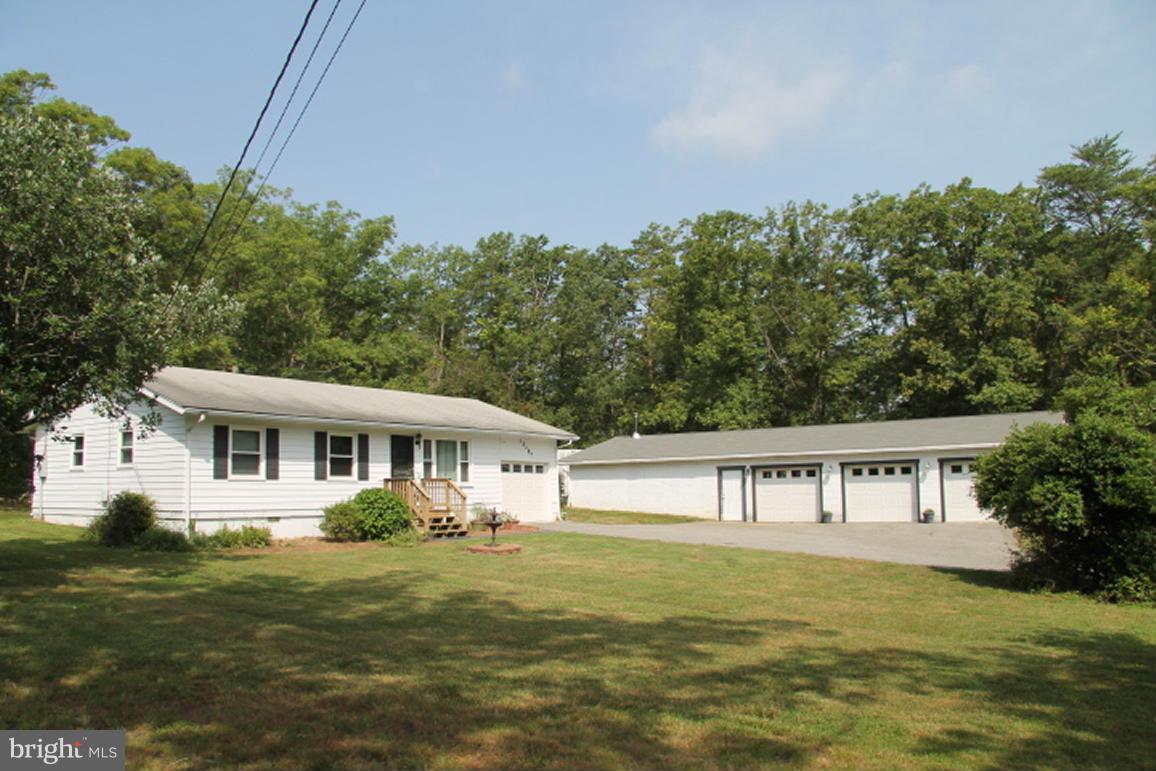 Nice 3 bedroom 2 full baths rambler on 5.5. acres, attached garage & an additional 3 car detached garage with workshop. The house has hardwood floors in the living room, hall, and all 3 bedrooms.The kitchen & both bathrooms have recently been updated. House also features mudroom in laundry area. Brick patio in rear of house.  Quiet country living. Garage has code box mounted on side entrance.