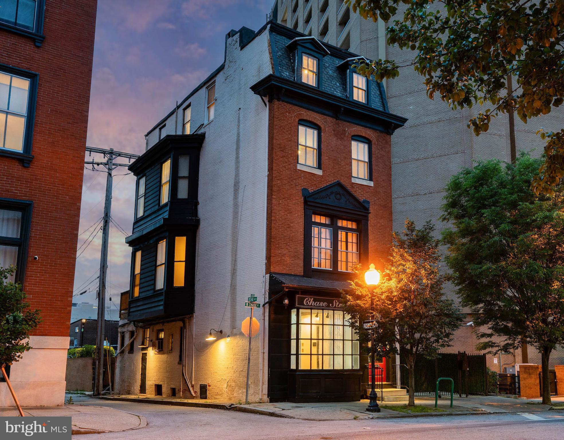 Live authentically. Steeped in history and perfectly situated in the energetic heart of Mt. Vernon, 17 W Chase St provides a rare opportunity to experience timeless architecture paired with remarkable versatility. Beautifully preserved details are found throughout including hardwood floors and elegant staircases that speak to its storied past. Offering exceptional flexibility, the entry-level floor—conveniently located just off the main entrance—is an ideal space for a business or an income-producing rental. Occupy the upper levels while generating supplemental income from the first floor or easily convert the space back to living quarters and enjoy the entire residence as one expansive home. Gather with friends and family in the sitting area with built-ins or in the refined dining space. Multiple gas stoves create warmth and ambiance throughout. Cook to your heart's content in the generously sized chef's kitchen, complete with a seating area and direct access to the outdoor deck where you can unwind and sip your morning coffee. The primary suite is a retreat of its own with a spacious bath, private sauna and custom walk-in closet. Additional bedrooms have generous proportions and are complemented by ample storage throughout the home. Parking options are available including the convenience of the garage directly across the street for a minimal fee and with free EV charging. Begin the new lifestyle you've always wanted and relish the very best of city living with restaurants, a grocery store, gym and so much more within your grasp. Walk to Penn Station for easy daily commuting. A truly special offering where historic elegance, modern flexibility and an unbeatable location seamlessly come together. See MLS# MDBA2217190 for the combined property listing for both 17 W Chase St and 19 W Chase St. Cultivate your existence. The art of uniting human and home.