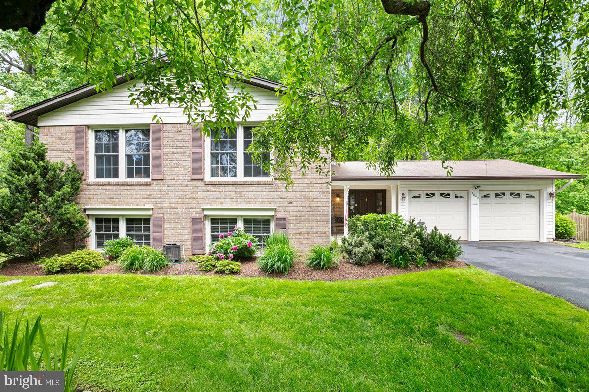 Home is much larger than it appears. This split foyer has a fantastic foyer that leads to the screened-in porch that includes a water feature and backs to woods that are great for bird watching and nature enjoyment. The house features 5 bedrooms and 3 full baths. The kitchen has been expanded for family gatherings and the matching updated cabinets include self-closing doors and pull-out bottom shelves that make cooking more functional. The kitchen is open to an eat-in breakfast nook with heated floors. Both the living and dining rooms have floor-to-ceiling windows that overlook a wooded lot. The wooded lot is home to wildlife, including deer and squirrels, which provides plenty of bird watching opportunities. The upper level offers 3 bedrooms and 2 full bathrooms. The primary bathroom has been updated, and all 3 rooms are large and have solid hardwood floors and ceiling fans. The hall bath is updated as well. The lower level offers 2 bedrooms and a full bathroom. The family room has new hardwood floors and a cozy fireplace. There's enough space to entertain upstairs, downstairs, outside, or on the screened-in porch. The house has a backup generator along with gutter guards. The home sits on a cul-de-sac, and Longwood Knolls has extensive sidewalks and trails to enjoy.