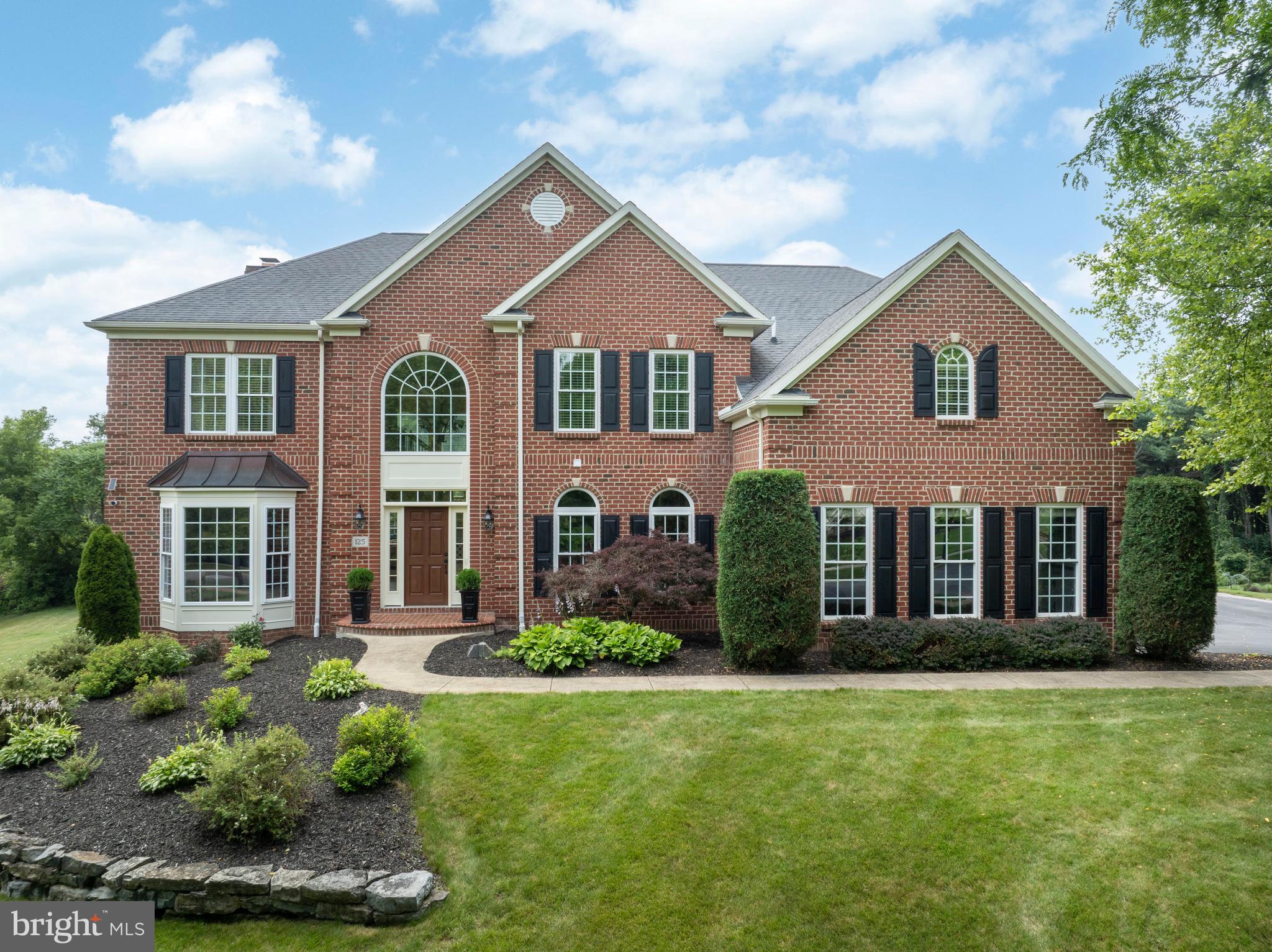 OPEN HOUSE - Sunday, July 12th, 1:00 - 2:30 PM
Welcome to this exceptional 5-bedroom residence in the highly sought-after Stearns Crossing neighborhood of State College! This solid brick, DeHaas-built home offers nearly 6,500 square feet of beautifully finished living space spanning across three levels. Step inside the impressive foyer, highlighted by a unique split staircase and soaring ceilings. To your left, a formal living room showcases expansive windows, while a spacious dining room with crown molding and wainscoting sits to your right. Continue toward the heart of the home—an expansive, open-concept kitchen, dining area, family room, and sunroom. Perfect for entertaining, the spectacular two-story family room features a stunning coffered ceiling and a floor-to-ceiling stone fireplace that serves as a dramatic focal point. Guests can gather around the extended island, enjoy casual meals in the eat-in kitchen, or relax in the light-filled sunroom, where abundant windows and skylights provide picturesque views all year long. Enjoy preparing meals in the kitchen featuring stainless steel appliances, including a gas range, oversized refrigerator, and double ovens, or mixing up drinks in the butler’s pantry. Additional conveniences include a walk-in pantry, mudroom, laundry room, dedicated office, and storage lockers, along with a three-car garage. Ascend upstairs to find the oversized primary suite that boasts a tray ceiling, dual walk-in closets, and a luxurious ensuite bath with two vanities, a jetted tub, radiant tile flooring, and a fully tiled walk-in shower. Down the hall are additional well-sized bedrooms featuring a shared Jack-and-Jill bath and walk-in closets—including one closet measuring over 17’ x 7’! A private fourth bedroom with its own ensuite bath and large walk-in closet is tucked away on the opposite wing, providing an ideal guest suite. Throughout the home, you’ll appreciate high-quality details such as 9’+ ceilings, radiant floor heat in all bathrooms, and ample storage.

 

The lower level offers thoughtfully designed living space with excellent finishes. Enjoy gathering up around the wet bar, staying warm by the stone fireplace, or settling into the theatre room for movie nights or the big game. This level also includes a generously sized bedroom, a fully tiled bath, an exercise room, and unfinished storage areas. Take in unforgettable evenings on the composite deck or in the hot tub overlooking the expansive, flat backyard that is adjacent to a peaceful wooded space.

 

You won’t believe you are only moments to Penn State University and downtown State College in this truly beautiful setting! Schedule your private tour today to see where function and craftsmanship meet excellence, at 125 Holly Ridge Drive!