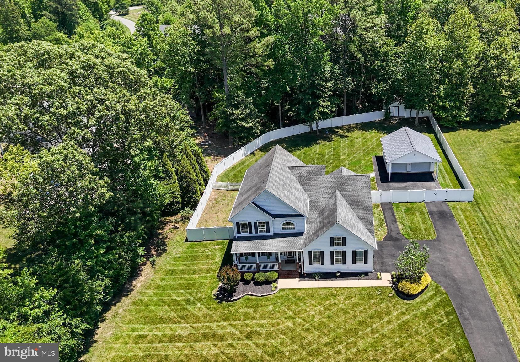 Custom Home with In-Law Suite, Private Backyard, and Dual Garages in Grandview Haven!

This beautifully maintained home offers the perfect combination of comfortable everyday living, entertaining space, and flexibility for multi-generational living. With 4 bedrooms, 4.5 bathrooms, and thoughtfully designed living areas, there's room for everyone to spread out and enjoy.

At the heart of the home is a two-story family room, flooded with natural light from oversized windows surrounding a gas fireplace. The spacious Eat-In Kitchen features upgraded cabinetry, granite countertops, a center island, range, 2nd wall oven, built-in microwave, and ample workspace for preparing meals. There is a separate room off of the kitchen which can easily serve as a formal dining room, sitting room, home office, or flex space. The Main-Level Primary Suite offers a peaceful retreat with a tray ceiling, dual walk-in closets, and a luxurious en-suite bath featuring dual vanities, a soaking tub, and a separate fully tiled shower. A convenient laundry/mud room and powder room complete the main level.

Upstairs, you'll find a spacious secondary bedroom with a private en-suite bath and large walk-in closet, along with two additional bedrooms that share a full bath. The Fully Finished lower level offers incredible versatility with a large family room/recreation area, dedicated theater room, full kitchen, full bath, and separate exterior entrance—making it ideal for an in-law suite, extended guests, or additional entertaining space.

Step outside and enjoy your own private backyard oasis. The fully fenced yard features privacy fencing, a separate fenced area for pets, beautiful stone hardscaping with a patio, and a built-in fire pit—perfect for relaxing evenings or hosting gatherings. The one-acre lot has an underground irrigation system that helps keep the lawn lush and pristine.

Car enthusiasts, hobbyists, and those needing additional storage will appreciate the attached oversized two-car garage, extended an additional two feet beyond standard depth, as well as the detached two-car garage built in 2021. The detached garage includes electricity, pre-wiring for a 240-volt outlet, and HVAC hookups, offering endless possibilities for a workshop, gym, or future finished space. A 16' x 12' storage shed provides even more room for lawn equipment and outdoor tools.

Additional upgrades include a whole-house generator and a tankless water heater for added comfort, efficiency, and peace of mind.

This exceptional property combines spacious living, thoughtful upgrades, and outstanding outdoor amenities. Don't miss your opportunity to call this one-of-a-kind property home.