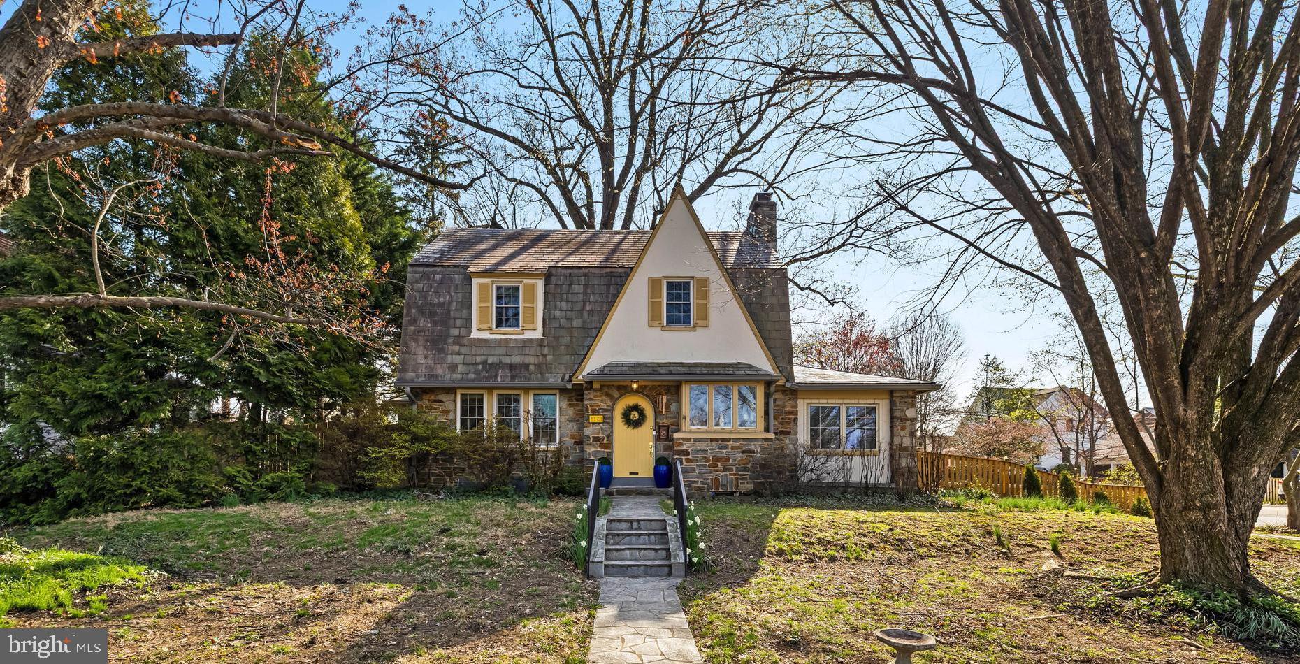 Welcome to  the Historic "Stoneleigh" neighborhood.....This charming Tudor-style home blends timeless character with thoughtful updates. Inside, you’ll find a cozy living room complete with a fireplace, built-ins and classic leaded glass windows—true hallmarks of Tudor design. The dining room continues this character-rich aesthetic, while the sunroom offers a bright and relaxing space to unwind. The beautifully renovated kitchen has stainless steel appliances, quartz counter tops, the space is both functional and inviting. The kitchen has field stone exposed walls. 42" cabinetry in gray adds warmth and personality, perfectly complementing the home’s unique style. Upstairs includes three comfortable bedrooms, a full bath and large hall linen closet. The lower level provides additional versatility with a small recreation room, powder room, and laundry area. Outside, enjoy a picturesque backyard with mature landscaping and a brick patio create the perfect setting for outdoor entertaining or quiet relaxation. There is detached two-car garage and extra parking. Updates include Windows(2022), Garage Door(2023), Fence (2025) Sewerline (2026) Garage Roof (2026) Repaired Slates on Main House (2026) Basement Waterproofing (2026)  Located in a highly desirable area with access to great schools, a community pool, and within walking distance to  the Charmery, Starbucks, Restaurants and your neighborhood hardware store.  This home offers both charm and convenience. There is  an annual voluntary  fee of $50 for the Stoneleigh Community Association.