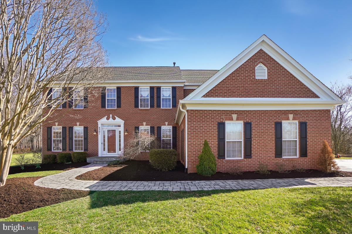 Welcome to 6301 Grafton Farm Dr.! This stunning brick front single-family home is situated on a sprawling 1.53-acre private lot, nestled in a peaceful cul-de-sac. Boasting over 5,300 square feet of living space across 3 finished levels, this home features 5 bedrooms, 4.5 bathrooms, and an attached 3-car garage.

As you step inside, you are greeted by a grand 2-story entryway and gleaming wood flooring that flows throughout the main level. The main level also features a dedicated office, formal living and dining rooms, and a gourmet eat-in kitchen. The kitchen is appointed with stainless steel appliances, including a gas range and wall oven, granite countertops, and an island with breakfast bar seating. The kitchen overlooks the sunroom, offering sweeping views of the lushly landscaped backyard and treeline. Step out from the sunroom onto your large back deck and stone patio, creating the perfect setting for outdoor entertaining.

The kitchen seamlessly flows into the family room, highlighted by beautiful picture windows that flood the space with natural light and a cozy gas fireplace.

The upper bedroom level boasts a luxurious primary bedroom retreat with stunning views of the backyard and conservation area. The ensuite bath features a double sink vanity, soaking tub, and walk-in shower with exquisite tilework detail. The primary suite also includes a walk-in closet with a custom organization system. The secondary bedrooms are generously sized, and one functions as a Jr. Suite with its own private bath.

The lower level is an entertainer's paradise with a huge rec room featuring a full built-in bar. There's also a potential 6th bedroom or flex space with an attached full bath and a large storage/utility room, providing ample space for your needs.

Additional features of this home include a built-in sprinkler system to maintain the lush lawn and security cameras for added peace of mind.

Conveniently located just minutes away from major commuter routes and transit options, this home also offers easy access to shopping, restaurants, local schools, and parks. Don't miss the opportunity to make this exquisite property your own! Schedule a showing today.