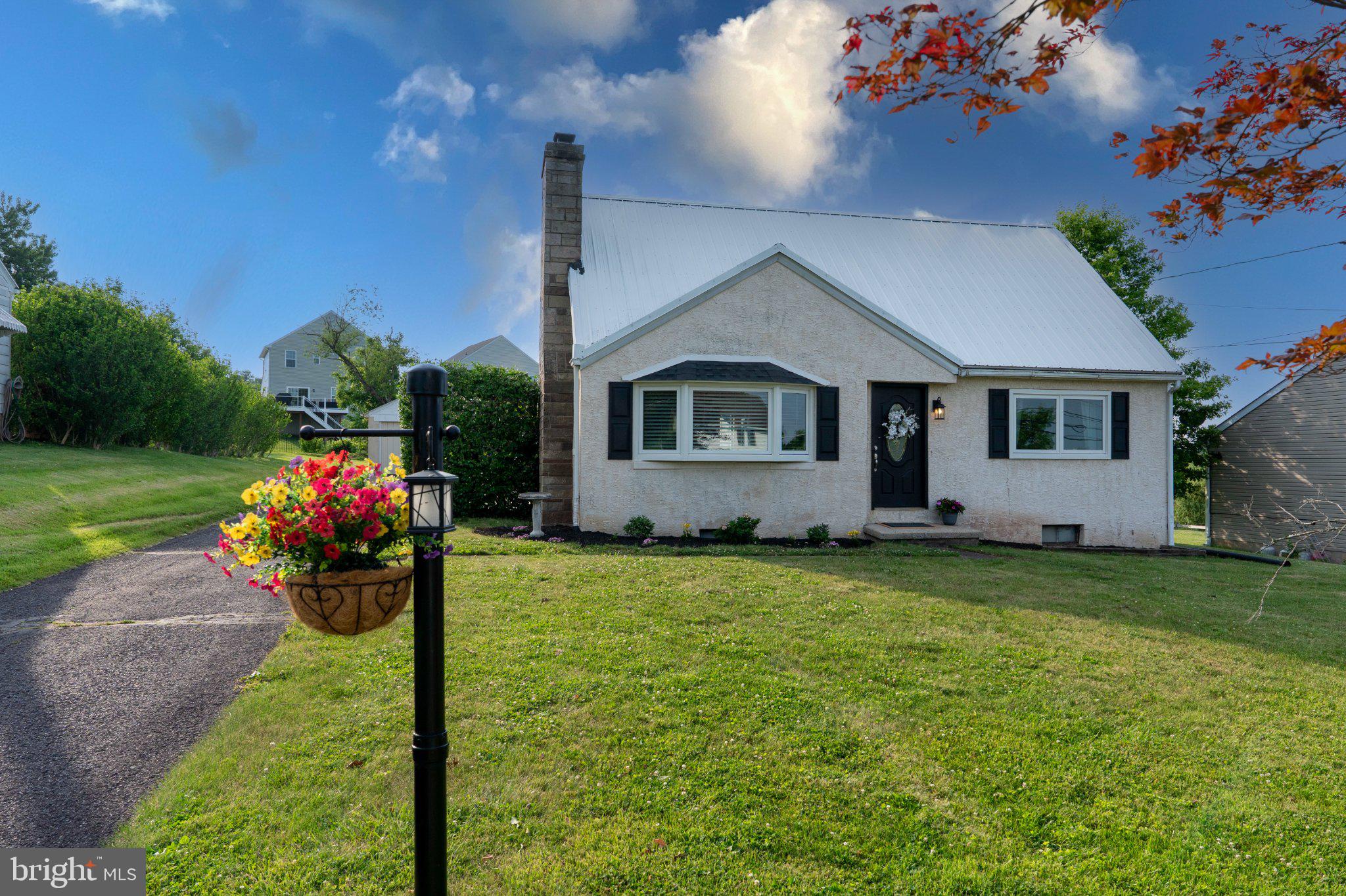 This charming Cape Cod-style home, built in 1951, offers a blend of classic design and modern amenities. With 3-4 bedrooms and 1.5 baths the interior features a traditional floor plan enhanced by built-ins, ceiling fans, and beautiful wood floors. The eat-in kitchen is equipped with essential appliances, including a built-in microwave, dishwasher, and refrigerator, making meal preparation a breeze. Enjoy cozy evenings by the stone wood-burning fireplace, a perfect focal point in the living area. The full basement provides ample storage space and features both interior and outside entrances, offering potential for future finishing. Replacement windows throughout enhance energy efficiency and natural light. On the exterior, the property sits on a generous 0.31-acre lot, featuring a front yard, rear yard, and side yards, ideal for outdoor activities or gardening. The oversized detached garage provides additional storage options. An outbuilding, such as this pole barn'garage, adds versatility for hobbies or equipment storage. One Side is gravel and one is concrete.  The property is conveniently located with easy access to local amenities. This home combines comfort, functionality, and potential, making it an excellent choice for those seeking an easy floor plan with plenty of room for everyone.