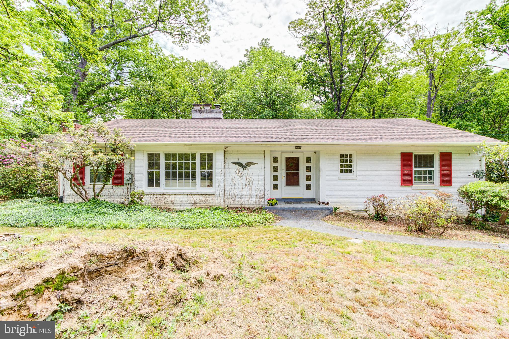 Classic rambler, needs TLC/updating or could be teardown on a beautiful wooded lot on a cul de sac.  Inside the Beltway in a neighborhood of luxury homes.  Great bones with 3 bedrooms and 2 baths up.  The sunroom addition has a wall of windows overlooking parkland with a fireplace as the focal point.  There is a large entry foyer, spacious living room with fireplace and an eat in kitchen.  The finished walkout lower level features a recreation room with built ins, bedroom/den, kitchenette and bath.   New water heater, new washer and dryer, new roof. Two fireplaces, attached garage.  Oil heat, no central AC. On over an acre, private wooded lot with great views. Fantastic Falls Church schools.  Easy commuting location, walk to bus stop and minutes to Beltway. Walk to Annandale Community Park. No HOA.