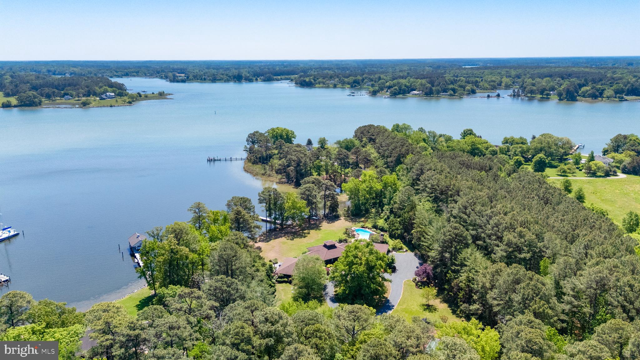 "Cypress Lodge" - Tucked away on a private waterfront lot along the Tred Avon River, this striking contemporary-style residence offers expansive water views, exceptional privacy, and thoughtfully designed indoor-outdoor living. The 3-bedroom, 5-bath home features an open floorplan filled with natural light, highlighted by soaring vaulted cathedral ceilings and clean architectural lines that create a bright, airy feel throughout. Designed to embrace its waterfront setting, the home seamlessly connects spacious living areas with multiple outdoor entertaining spaces overlooking the river. The well-thought-out outdoor living space was designed to fully maximize the property’s incredible waterfront setting, complete with a pool, outdoor fireplace, and covered pavilion overlooking both the pool and the water. Whether hosting guests or enjoying a quiet evening at home, the outdoor spaces offer a seamless extension of the home’s contemporary design and relaxed Eastern Shore lifestyle. Additional exterior amenities include a private dock, private tennis court, and hot tub, all surrounded by mature landscaping and a peaceful setting that enhances the property’s sense of seclusion. Ideally located just outside of Easton, the property provides convenient access to Washington, D.C., Baltimore, and Philadelphia, making it an exceptional full-time residence or weekend getaway within reach of several major metropolitan areas.