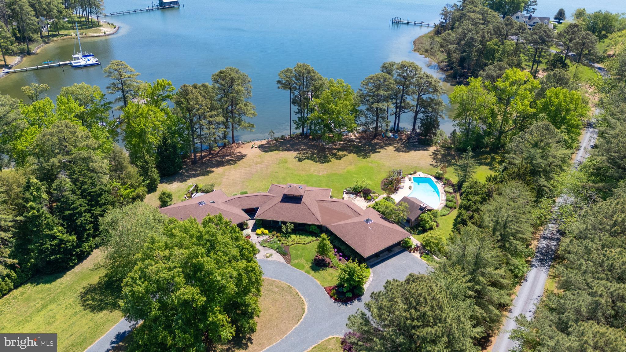 "Cypress Lodge" - Tucked away on a private waterfront lot along the Tred Avon River, this striking contemporary-style residence offers expansive water views, exceptional privacy, and thoughtfully designed indoor-outdoor living. The 3-bedroom, 5-bath home features an open floorplan filled with natural light, highlighted by soaring vaulted cathedral ceilings and clean architectural lines that create a bright, airy feel throughout. Designed to embrace its waterfront setting, the home seamlessly connects spacious living areas with multiple outdoor entertaining spaces overlooking the river. The well-thought-out outdoor living space was designed to fully maximize the property’s incredible waterfront setting, complete with a pool, outdoor fireplace, and covered pavilion overlooking both the pool and the water. Whether hosting guests or enjoying a quiet evening at home, the outdoor spaces offer a seamless extension of the home’s contemporary design and relaxed Eastern Shore lifestyle. Additional exterior amenities include a private dock, private tennis court, and hot tub, all surrounded by mature landscaping and a peaceful setting that enhances the property’s sense of seclusion. Ideally located just outside of Easton, the property provides convenient access to Washington, D.C., Baltimore, and Philadelphia, making it an exceptional full-time residence or weekend getaway within reach of several major metropolitan areas.