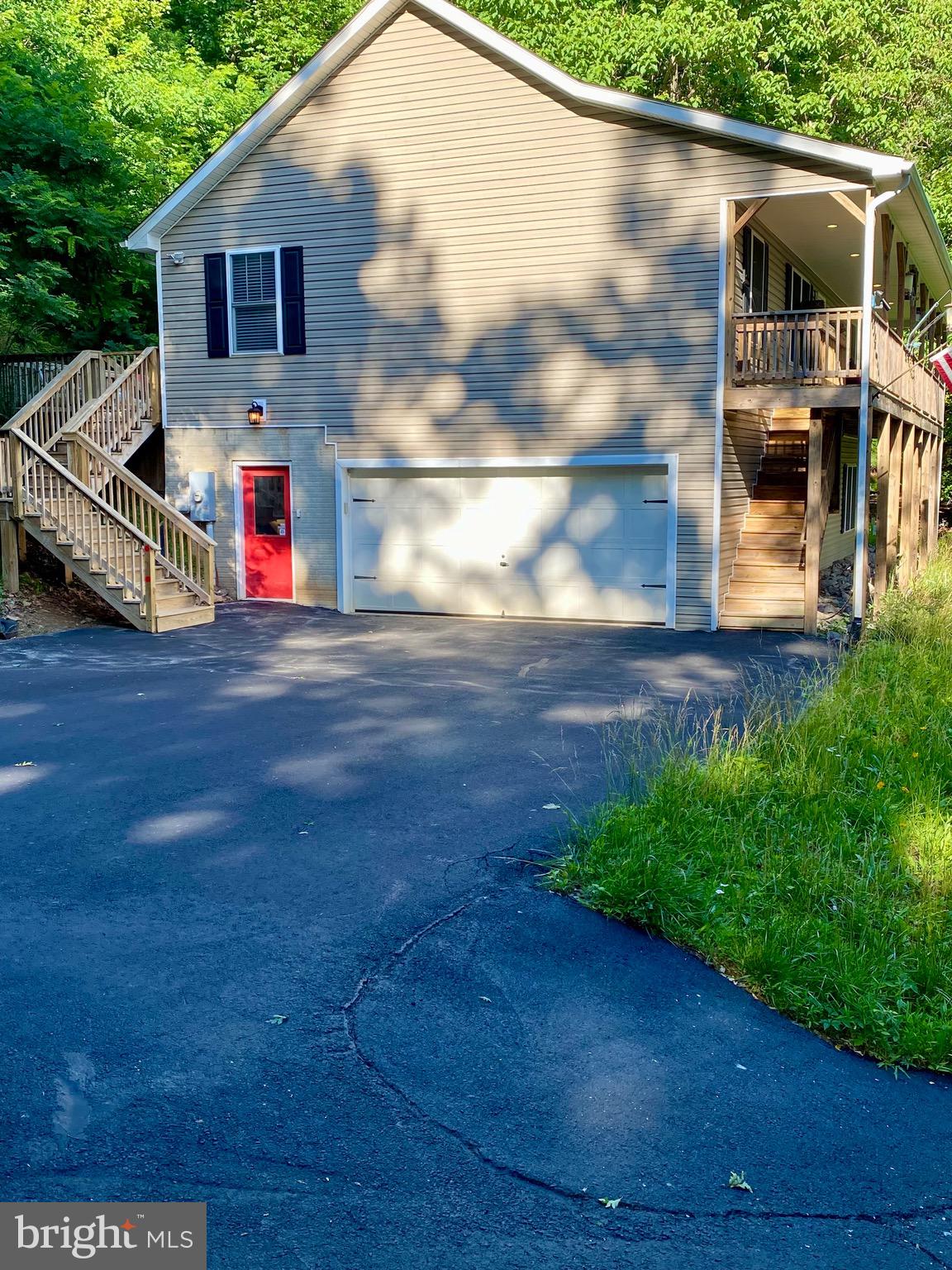 This inviting 3-bedroom, 3-bathroom split floor plan home offers the perfect blend of unbeatable location and serene natural beauty. The lower level offers a  private retreat space featuring a large family/flex room and a nice size handicap accessible full bathroom.  There is a  perfect area tucked away for an extra full refrigerator. The large laundry area has plenty of room for extra storage and large counter spaces. New well pump 2026. Situated just 5 minutes from I-66, it provides effortless access for commuting, quick trips to the city, or weekend getaways-yet feels worlds away thanks to its peaceful mountain
setting.
Step onto the expansive front porch-your personal front-row seat to nature's daily show. Settle into a rocking chair with morning coffee or an evening glass of wine, and soak in the dramatic sunsets that paint the sky in vibrant oranges, pinks, and purples over the rolling mountains. This spot is truly a bird lover's paradise: colorful songbirds flit between branches, hummingbirds dart to nearby blooms, and woodpeckers tap away in the distance. Squirrels scamper playfully across the lawn, and deer often graze. The entire front and back yard beyond the deck along with side yard along driveway has been thoughtfully seeded over $1,000  worth of  vibrant mix of wildflowers and tall, cheerful sunflowers, creating a low-maintenance meadow that bursts with color and add to curb appeal.  The owners also installed gutter guards to help with home maintenance. 
Inside, the open and airy floor plan flows beautifully, highlighted by a spacious kitchen that's a cook's dream: abundant counter space,
generous cabinets giving plenty of storage in addition to a large pantry, stainless steel appliances, and a double oven with built-in air fryer for all your baking and roasting adventures.
For gatherings and relaxation, the wide back deck stretches across the entire rear of the home, creating multiple entertainment zones ideal for barbecues, outdoor dining or unwinding with friends. There is plenty of room to add a hot tub to enjoy basking under the starry night sky.
Practical perks include a large 2-car garage with extra expansion space and built-in shelving for storage, plus lots of extra parking space in the driveway and yard-perfect for hosting friends, family gatherings, or weekend visitors without ever feeling crowded