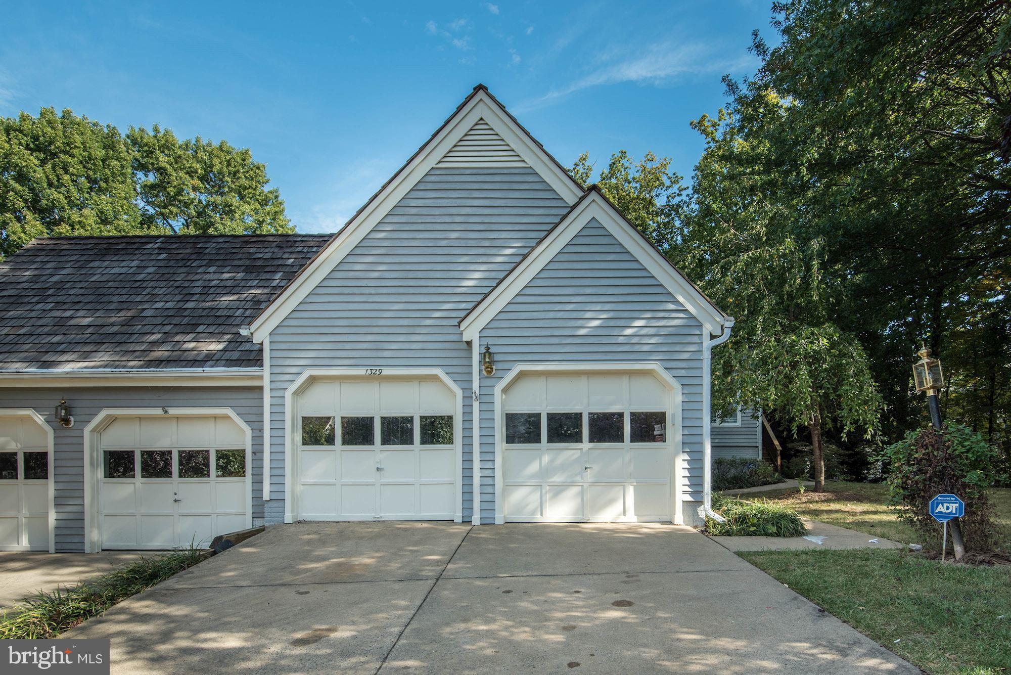 **NEW LISTING** Rarely available & sought after 2 level end unit sited at the end of a cul de sac complete with a 2 car, detached garage & wrap around deck. Hardwood floors on the main level along with a bright, open & airy layout & 2 bedrooms. The walkout lower level features a large rec room w/ wet bar, bedroom/ full bath a bonus room & large storage/laundry room. Central Vac & more. OH 10/8 1-4