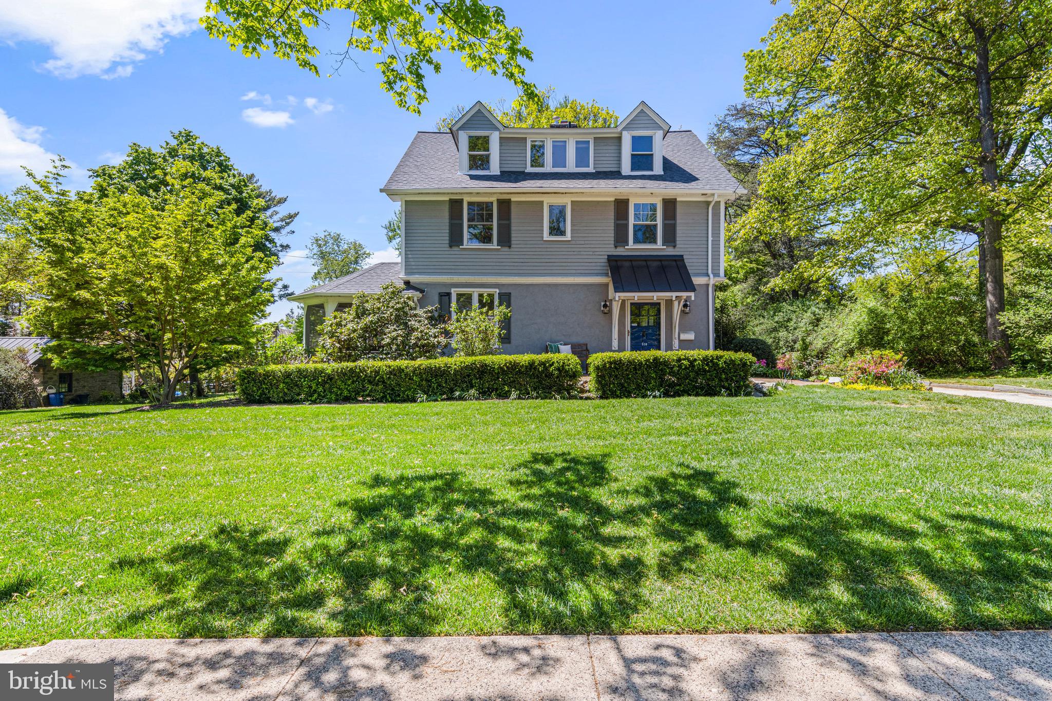 Commanding a formidable presence on one of Swarthmore’s most iconic, tree-canopied streets, this sprawling 1930s farmhouse-style residence offers a rare synergy of vintage character and modern, open-concept living. Situated on a magnificent landscaped lot, the property is a masterclass in indoor-outdoor living! The updated kitchen serves as the central hub, featuring a large center island with beautiful stained wood top and stylish pendant lighting and a charming custom backsplash. It flows seamlessly through sliding doors to an expansive deck—complete with a built-in picnic bench—perfect for alfresco dining and summer grilling. For everyday convenience, a side entrance opens into a transition area featuring a fabulous mudroom, dedicated laundry area, and a discrete powder room.  Just beyond the kitchen, the sun-drenched dining room boasts two oversized windows, including an inviting window seat that offers serene views of the surrounding greenery. The expansive living room stands as the home’s focal point, centered by a classic wood-burning fireplace and elegant built-in bookshelves. French doors lead from here to the home’s most enchanting feature: an idyllic screened porch that captures the cooling breezes!
The second floor is intelligently designed with four spacious corner bedrooms, ensuring every room is flooded with natural light. This level includes a dedicated hall bath, one bedroom with a private half-bath, and another featuring a full en-suite.  The entire third floor has been transformed into a luxurious primary suite. This massive retreat includes:An expansive bedroom and private sitting area, a dedicated home office/exercise room, a walk-in closet and a beautifully appointed en-suite bathroom.
Whether you are hosting on the screened porch, the large deck, or the ground-level brick patio, the outdoor entertaining options are unmatched. In addition, the offerings in this location are incredibly convenient! The house is just up the street from Henderson Field and the Swarthmore Swim Club and a short, scenic way to downtown Swarthmore, the SEPTA rail line, the local elementary school, and even your morning coffee at Starbucks. This is more than a house; it’s a tranquil respite from the chaos of everyday life. Experience the best of Swarthmore living.
