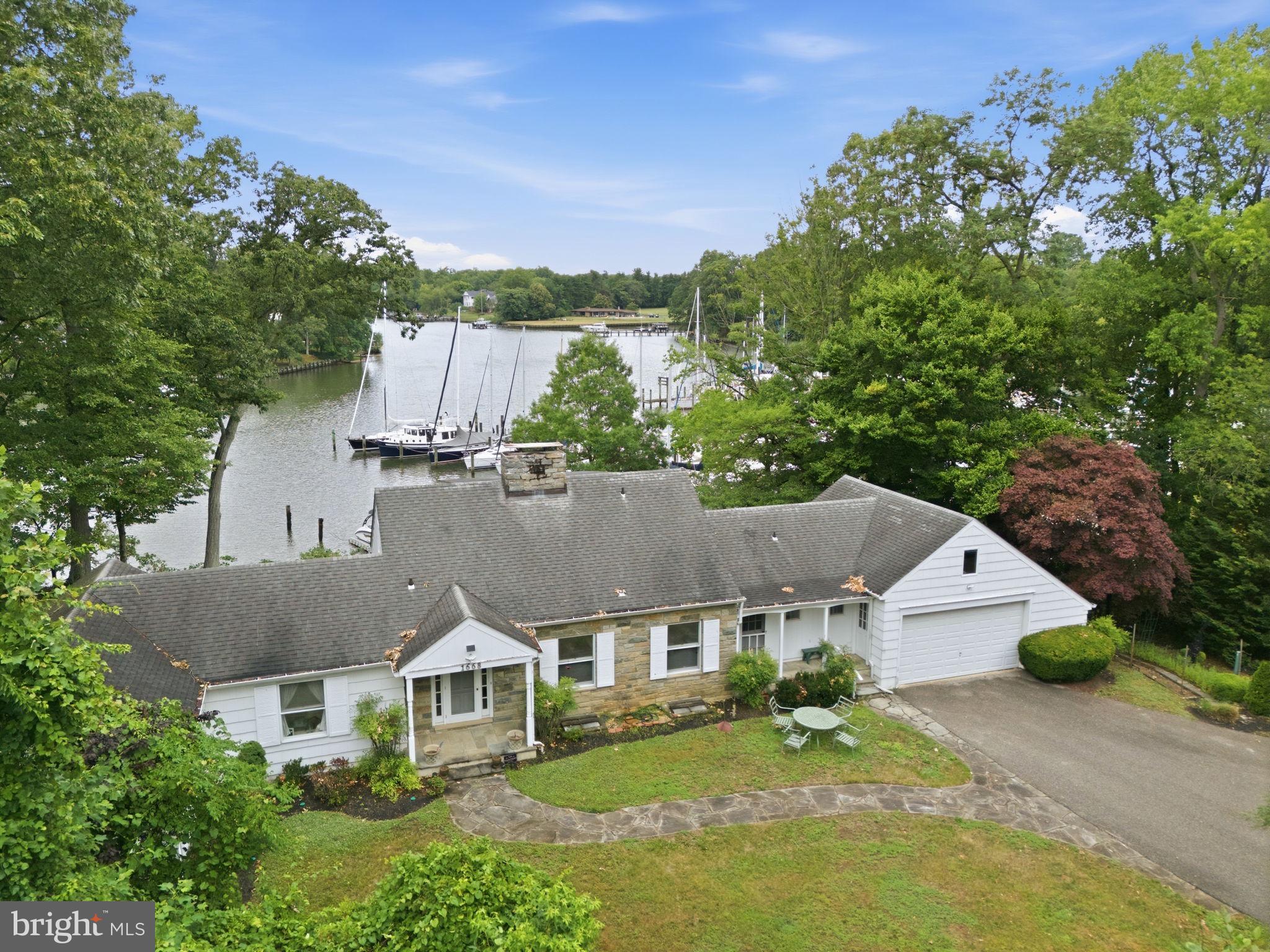 Rare opportunity to own a true deep-water waterfront property offering breathtaking, tranquil views of Whitehall Creek. With approximately 8 feet of water depth in the slips and 11 feet at the end of the pier, this exceptional property is a boater's dream, providing effortless access to deep water and the Chesapeake Bay beyond. The gentle approach from the backyard to the pier is an added luxury rarely found on waterfront properties. Cherished by the same family for nearly four decades and enjoyed by three generations, this special home is ready for its next chapter. Whether you choose to renovate, expand, or build the waterfront retreat you've always envisioned, the possibilities are endless. The generous footprint and public sewer connection create an outstanding opportunity to design and customize your dream waterfront residence. The main level offers expansive living spaces perfectly suited for gatherings of any size, including a spacious kitchen, oversized dining room, and an impressive family room designed for entertaining while capturing beautiful water views. A highly desirable feature, the main floor includes three bedrooms, two of which are positioned waterfront and one offering a private ensuite bath. Upstairs, the oversized primary suite serves as a peaceful retreat, showcasing stunning panoramic views of Whitehall Creek and a private ensuite bathroom. The walkout lower level adds even more living space with a large recreation/family room centered around a striking stone fireplace, along with an additional full bathroom, bringing the home's total to four full baths. Properties offering this combination of deep water, protected harbor, spectacular views, public sewer, and unlimited potential are exceptionally rare. Create the waterfront legacy property you've always dreamed of in one of Annapolis' most coveted waterfront settings!!