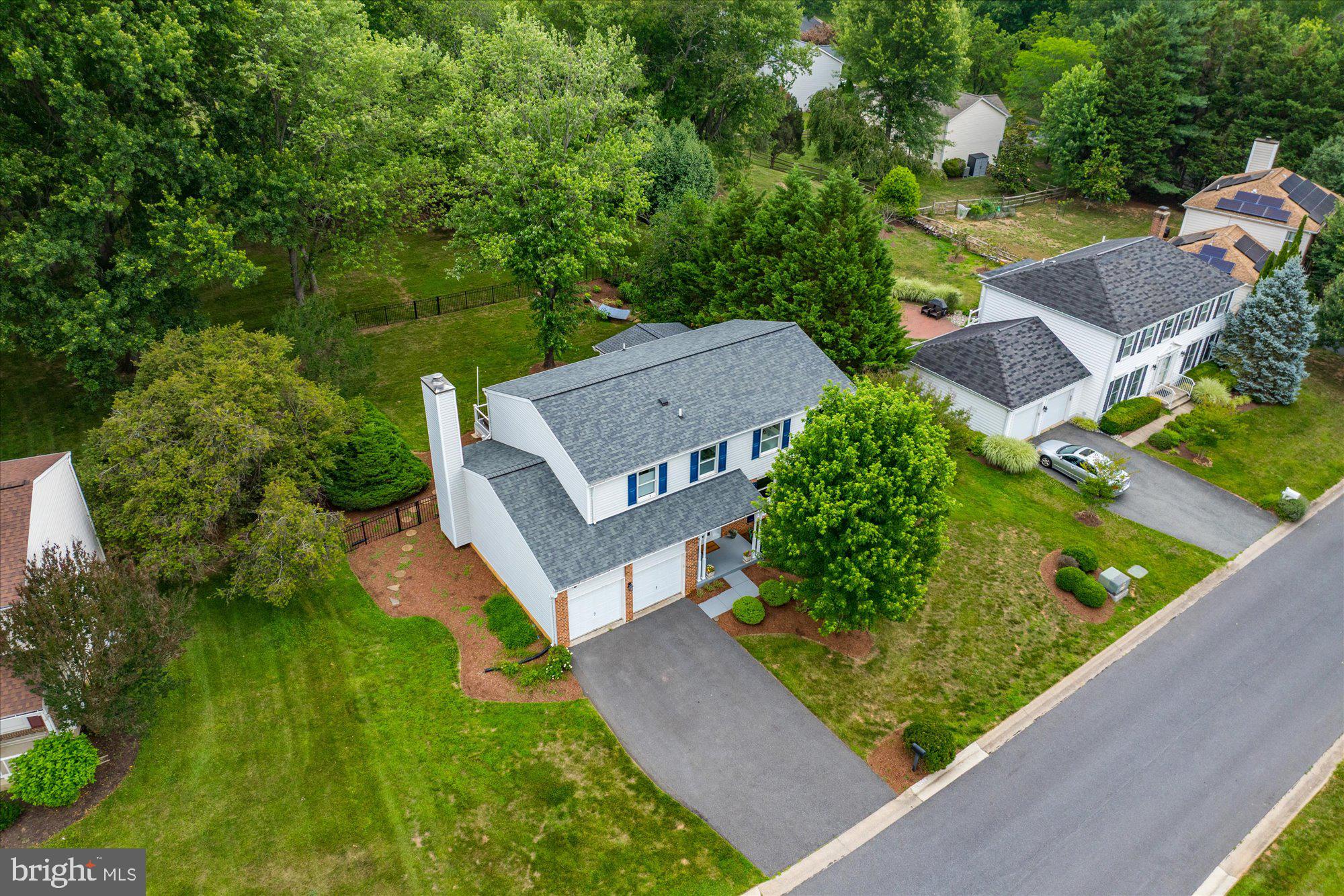 Welcome to 11209 Maine Cove Drive, a stunning colonial with over $250,000+ in thoughtful renovations (2022–2024), nestled on a premium lot backing to two acres of serene green space in the sought-after Dufief Mill community. This home has been meticulously updated throughout and is move-in ready, including a major four-season sunroom addition. offering modern luxury and timeless comfort.
The home boasts a renovated gourmet kitchen with Wellborn custom cabinetry, under-cabinet lighting, granite countertops and backsplash, stainless steel appliances with an induction range, and commercial-grade ventilation. The kitchen flows seamlessly into the spacious family room, which features a distinctive bay window, wood-burning fireplace with a painted brick accent wall, and custom built-in bookshelves. The dining room, with crown molding and large windows, opens to both the kitchen and a cozy sitting room.

The Crown Jewel of the home is the new four-season sunroom addition (2023), complete with hardwood floors, a sound system, recessed lighting, custom blinds, and a ceiling fan. French doors lead to a 400+ square foot composite deck (also new in 2023), featuring a hot tub, Bose outdoor speakers, and ambient lighting—perfect for entertaining.

The upper level is a sanctuary of relaxation. The primary suite is a retreat unto itself, featuring a spa-inspired soaking tub, walk-in shower, double-sink vanity, and a designer custom walk-in closet with frosted glass doors and motorized blackout shades. Secondary bedrooms include built-in closets, blackout blinds, and ceiling fans, while the hall bath offers sleek modern finishes. A brand-new laundry room, equipped with high-capacity LG appliances, expanded linen storage with a custom Elfa system, and a built-in ironing board, adds ultimate convenience.

The finished lower level includes a legal bedroom with an egress window, a full bathroom, and five closets with built-in shelving. Waterproof laminate flooring, modern lighting, and raised ceilings complete this versatile space, perfect as a recreation room, guest suite, or home office.

Curb appeal abounds with a newly resurfaced and widened driveway, painted front porch, and new front walkway. The backyard features professional landscaping and powder-coated aluminum fencing, while the garage has been fully updated with fresh drywall, paint, rewired electrical, and additional outlets.
Enjoy easy access to an abundance of shopping, dining, and entertainment venues, including the Kentlands, Falls Grove Village Center, Downtown Crown & Rio, Westleigh Rec Club, Stonebridge Swim Club, Lakewood Country Club, and more. Perfect for commuters, this home is just minutes from Rt. 28, I-270, ICC, and Shady Grove Metro, making it an ideal location for convenience and connectivity. Located in the Wootton School District this move-in ready home is truly exceptional. Don’t miss the opportunity to make this extraordinary property yours.