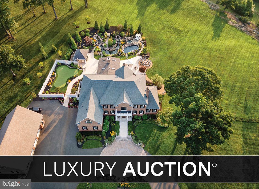 Selling at Luxury AUCTION Without Reserve on March 5, 2026! List price for REFERENCE ONLY. Offered in co-op. with Platinum Luxury Auctions. *NOTE: Property offered individually or packaged with 7464 Wilson Road. Refer to Luxury Auction® Terms of Sale and to listing of 7464 Wilson Road. Inquire for details.

Experience the magic of Rosewood, a Virginia Hunt Country Estate unlike any other.  

Unassuming from the public road, a paved drive meandering through the woods gives way to the magnificent gated entrance.  Through the massive gates, a sweeping lawn, lake with lighted fountain and a winding, lamp-lit paved drive leads you home - Rosewood’s 116 acres offer absolute privacy and a lifestyle that feels more like a luxury resort than a private residence. Set high among rolling fields with panoramic Blue Ridge views, this exceptional property combines timeless architectural elegance, world-class amenities, and true off-grid capability for complete self-sufficiency.

The 10,000 sq. ft. brick Colonial main residence showcases newly refinished cherry wood floors, soaring ceilings, and sun-filled spaces. The 2021-renovated gourmet kitchen features Wolf and Sub-Zero appliances, granite countertops, and a spacious island. Formal entertaining rooms flow to a library and a serene sunroom with a fireplace and garden views.

The primary suite is a tranquil retreat with a spa-inspired bath, steam shower, radiant heated floors, and an oxygenated Jacuzzi tub. Four additional ensuite bedrooms ensure privacy for family and guests. The lower level offers a redwood dry sauna, fitness room, wine bar, home theater, wet bar, and cedar closet.

Resort-Style Outdoor Living
A granite pool/spa and fish pond with cascading waterfalls and spectacular landscaping anchor the backyard, complemented by a panoramic firepit terrace with mountain views. The chef’s outdoor kitchen includes a Forno Bravo pizza oven, Memphis pellet smoker, Green Egg, Blaze grill, bar seating, hotplate, ice maker, beverage refrigerator, sink, and storage — all beautifully lit for evening gatherings.

Recreation continues with a PGA-quality putting green, a stocked 1.8-acre pond with dock, stone patio, and a programmable lighted fountain.

For the Collector & Sports Enthusiast
The climate-controlled detached 4-bay garage features an authentic professional race car simulator, PGA-quality golf simulator, and three commercial-grade hydraulic car lifts.

Orchard & Grounds
A fenced orchard produces apples, pears, peaches, nectarines, plums, persimmons, berries, and rare jujube fruit. Lush landscaping is maintained by an elaborate irrigation system drawing from the pond, with LUXOR programmable lighting throughout.

Off-Grid Ready
A POWUR-owned solar array and upgraded SPAN power panels power the property , supported by two Generac backup generators, private well and septic, and on-site fuel storage. Dual camera systems, smart gate control, and monitored access provide exceptional security.

Though it feels like worlds away, Rosewood is just minutes from Warrenton’s shops, dining, and services — accessible via smooth, paved roads. More than a home, it’s an escape, a statement, and a legacy to be enjoyed for generations.