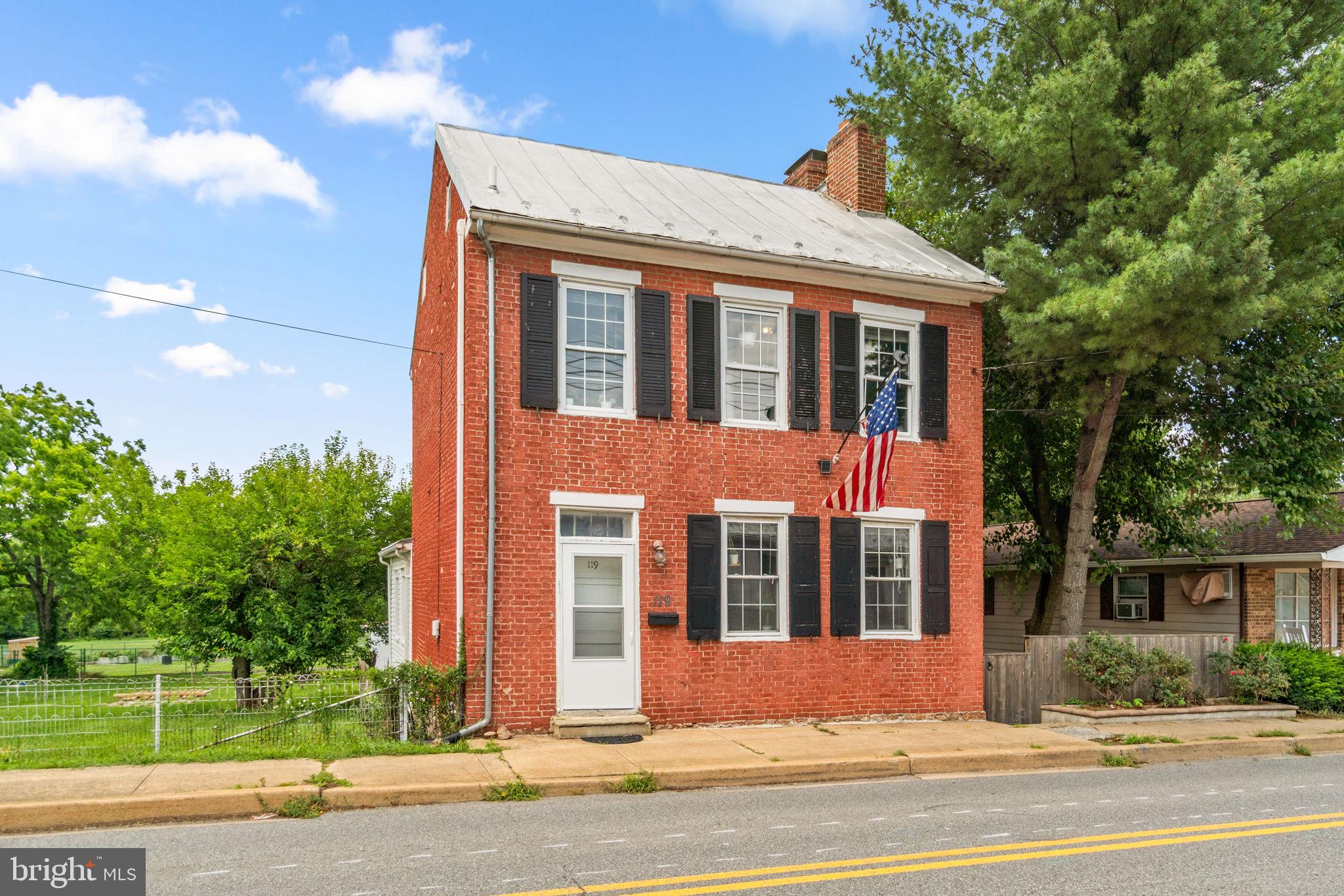 Step back in time while enjoying modern comforts in this charming pre-Civil War 1850 Federal-style home located in the heart of historic Boonsboro. Rich in architectural character, this home is larger than it appears and showcases timeless details including double chimneys, Flemish bond brickwork, cut limestone window lintels, a grand side entry hall with a dramatic three-story open staircase, and beautifully refinished random-width hardwood floors, with exciting potential for future expansion in both the attic and basement. The upper level features two spacious bedrooms and a full bath. The main level offers a welcoming front parlor, a recently renovated kitchen, and a generous family room perfect for everyday living or entertaining. The lower level includes a partially finished basement with additional unfinished space for laundry, storage, and utilities. Step outside to enjoy the fully fenced backyard with alley access, off-street parking, and a one-car garage. Better yet, the property backs directly to the 50-acre Shafer Park, offering walking trails, sports fields, playgrounds, concerts, festivals, and year-round recreation just beyond your backyard. Located only 0.2 miles (approximately a 4-minute walk) from downtown Boonsboro, you'll enjoy easy access to charming shops, local restaurants, museums, and community events. Outdoor enthusiasts will appreciate being just minutes from Crystal Grottoes Caverns, Washington Monument State Park, Greenbrier State Park and Lake, Antietam National Battlefield, South Mountain State Park, Devil's Backbone County Park, and many other historic and recreational destinations. Whether you're searching for a full-time residence, an active lifestyle, or the perfect weekend getaway, this unique historic home offers the best of small-town charm, outdoor adventure, and Maryland history. Come experience everything historic Boonsboro has to offer!