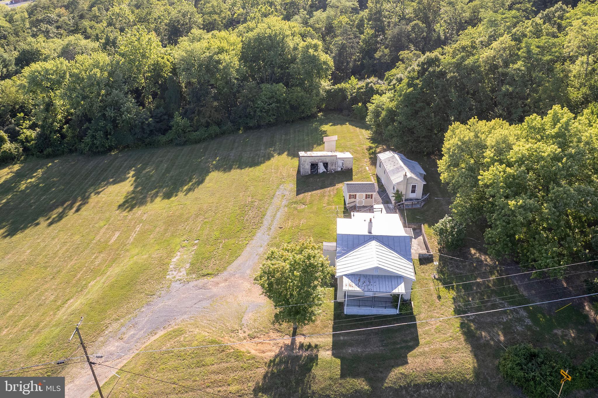Set on 1.4 acres with beautiful long-range views, this well-built home is ready for someone to bring it back to life. A strong structure, a covered front porch, and a generous lot give you space to breathe, all just minutes from downtown Winchester and Winchester Medical Center. With a little vision and renovation, this could become someone's dream home, whether that's a full modern transformation or a labor-of-love restoration that honors its original character. The real bonus is the rear outbuilding with three rooms. A blank canvas ready to become a guest suite, studio, home office, or whatever your imagination needs it to be. A second shed adds extra storage, so there's room for tools, toys, or projects. Location seals the deal, quick access to Old Town Winchester's shops and restaurants just down the road and route 37 minutes away makes for easy commuting. Schedule your showing today!