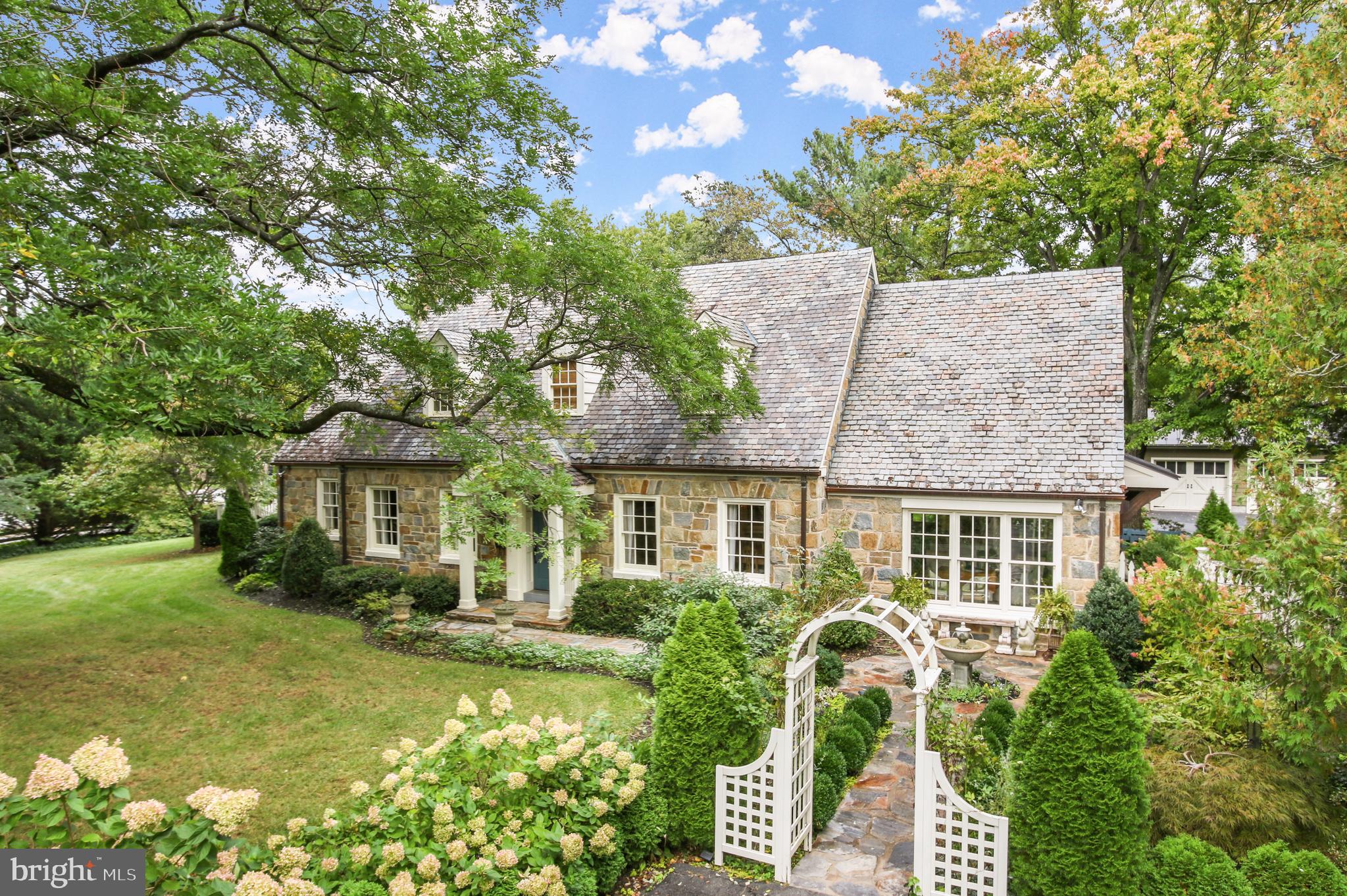 TRULY SPECIAL, STUNNING AND AESTHETICALLY A GIFT to anyone who will reside in this custom stone and Hardie Plank home (Eden’s Gate). The owners, one of which is an interior designer, expanded and remodeled this gem in 2015 with renowned Architect, Thomas Gilbride. They did so while retaining the charm of a 1930’s home in the historic district of sought-after Leesburg, VA. One of the most revered homes downtown (as the Listing Agent, I agree) sits for enjoyment for everyone’s pleasure just before Morven Park Road which is near parks and the commuter routes. Trust me when I share that not only is the home itself and setting so rare with sidewalks through Town, but also having acreage, owning your own SEPARATE GUEST HOUSE and separate DETACHED GARAGE is too. This piece of paradise is proudly presented on 1.2 ACRES with numerous perennial gardens, niches, water features, stone patios, walkways and views on all sides – as if this were not enough, the landscape includes substantial hardscape with stone walls, a large parking pad for guests and all of this was manicured in true fashion with the rest of the home down to its own 22-Zone Irrigation System.  With an interior designer living here, one will appreciate the quaint stone patios, the new side porch and greenery viewed through the French Doors of the Owner’s Suite, and all brought inside from the picturesque windows. The high-end finish (METAL AND SLATE ROOF) and workmanship (functional) features are found throughout - in the custom Luxury Bath, in multiple built-ins, gorgeous tiles, crown moldings, board ceilings, designer light fixtures and much more. The custom paint palette assists the floor plan as it flows mainly on one level from room-to-room with an inviting sunroom with walls of windows and a remodeled dream Chef’s Kitchen with appliances to include:  Sub-zero designer series (fully built-in flush with counters) 36” refrigerator and 30” wine cooler, Marvel icemaker, Thermador 5 burner gas cooktop with downdraft vent, and an oven stack (with microwave, oven, warming drawer) and Bosch dishwasher.  You will appreciate how meticulous the owners of this property are and their love for it shines through - also in a well-thought-out floor plan. It includes 3 fireplaces (2 are gas and one is deemed a furnace), radiant heat flooring, aging in place features like grab bars, pocket doors to accommodate wheelchairs in the main Owner’s Suite.  The love of design and aesthetics will bring a smile to your face as you walk through a one-of-a-kind home. Moving on to a special guest home, it  offers two bedrooms (one is used as a studio/office), a full bath, laundry room, an eat-in kitchen and living room and rear deck. What is marvelous about this property, and not to be missed, is the guest house has a separate entrance and driveway on Morven Park Road which rear yard is buffered with privacy and foliage from the main residence while both back to the rear yard. Extended family and/or guests will have everything they need when staying in this self-sufficient guest home and residence. Also on premise is the newer (2016) Detached 2-Car Garage with a metal roof and its own Electric Vehicle Charging System. This too is surrounded by more perennial gardens and views. The Garden Shed, for the home gardener, overlooks a spacious rear yard with outside soothing water features/fountains and a stunning variety of landscape enjoyed also from the interior. If the uniqueness of this home in the sought-after historic district filled with shops, restaurants, music, events yet close to commuter routes is not enough, Leesburg was recently voted #8 “Best Places to Live for families” by Fortune Magazine 2022. The multi-zoned HVAC was also updated in 2015 to a natural gas system with a new high-efficient boiler and water heater.  Tax record is wrong -Appraiser measured Main House 3114 sf finished + 879 Cottage finished sf.  Listing shows totals and beds/baths.