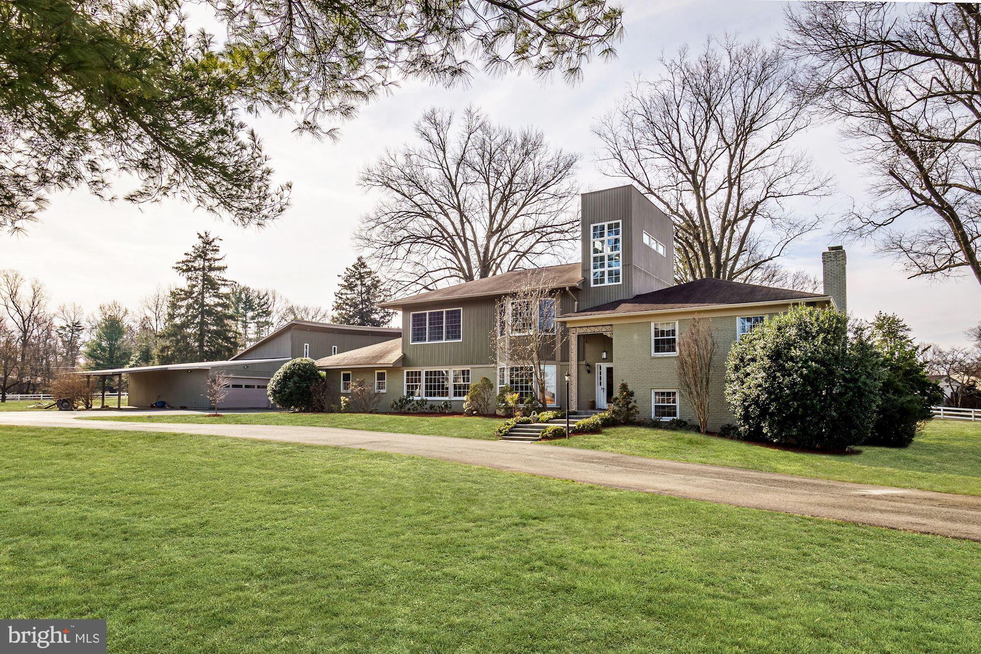 Ideally located in close proximity to Virginia and downtown Washington, this special property, sitting on a 2 acre corner lot, overlooks Congressional Country Club and is across from the historic Hermon Presbyterian Church. The  heart of the home  is the renovated kitchen with a large center island. There is a breakfast area with a built-in banquette opening to the living room with an antique oak fireplace. The adjacent dining room is perfect for entertaining, with wood paneling and two sets of glass sliding doors leading to the pool and backyard. A family room, with a vaulted wood ceiling, would make a perfect first floor bedroom with an adjacent full bathroom.The upper level has three bedrooms (one being the original master bedroom) and two full bathrooms. In 2007, the owners added a third level with a master suite, and a second large bedroom also with en-suite bathroom. The two story hall with windows is a dramatic architectural feature. The lower level has a recreation room with a corner brick fireplace and a full bathroom. The home"s updates include a newer roof, a new above-ground oil tank (installed in 2016) and an updated HVAC system. There is a kidney shaped pool for outdoor enjoyment. A bonus is a wonderful two-story structure with 4950 sq. ft.,  heated floors and 6 hinged doors for easy access that can be used in a variety of ways.  CAR COLLECTORS TAKE NOTE ROOM FOR 16 CARS!