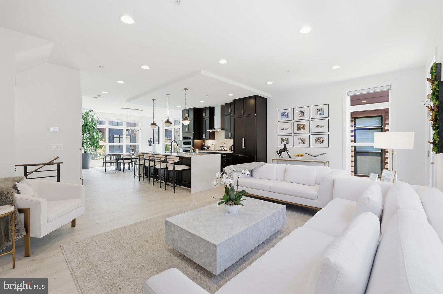 Priced to sell. Welcome to this beautifully upgraded, sun-filled luxury end-unit townhome offering the perfect blend of modern elegance, comfort, and thoughtful custom design. Every detail of this home has been carefully curated to create a warm, inviting atmosphere that is both functional for everyday living and exceptional for entertaining.

With over $200k in premium upgrades and designer enhancements, this stunning residence features soaring 9.5-foot ceilings, abundant natural light throughout every level, and seamless open-concept living spaces designed for today’s lifestyle. The gourmet chef’s kitchen is a true centerpiece, showcasing top-tier cabinetry and appliances, Quartz countertops, an expansive waterfall island with abundant storage, upgraded tile backsplash, under-cabinet lighting, and a polished high-end feel throughout.

The home includes numerous custom upgrades that make it truly one of a kind, including a beautifully built-in fireplace with custom shelving and wallpaper, elegant bar cabinetry with antique mirrors, a second pantry for additional storage, customized his-and-her closets, mirrored closet doors with built-in mirrored accents, custom children’s bedroom closets, added rail shelving throughout all closets, and extensive garage shelving for optimal organization.

The loft level and outdoor spaces have also been thoughtfully enhanced with upgraded outdoor tile and pavement, creating the perfect retreat for relaxing or entertaining.

Sunlight pours through every level, creating a bright and welcoming ambiance you’ll love coming home to. Move-in ready with timeless finishes, refined details, and exceptional functionality, this home offers luxury living at its finest.

Residents enjoy access to exceptional community amenities, including pool, elegant clubhouse, state-of-the-art fitness center, yoga studio, beautifully landscaped gathering spaces with cozy firepits, BBQ areas, and meticulously maintained common areas — offering the perfect blend of luxury, convenience, and community right at your doorstep.

Complete with an oversized two-car garage and located in one of Rockville’s most desirable communities, this exceptional home is truly a rare opportunity.