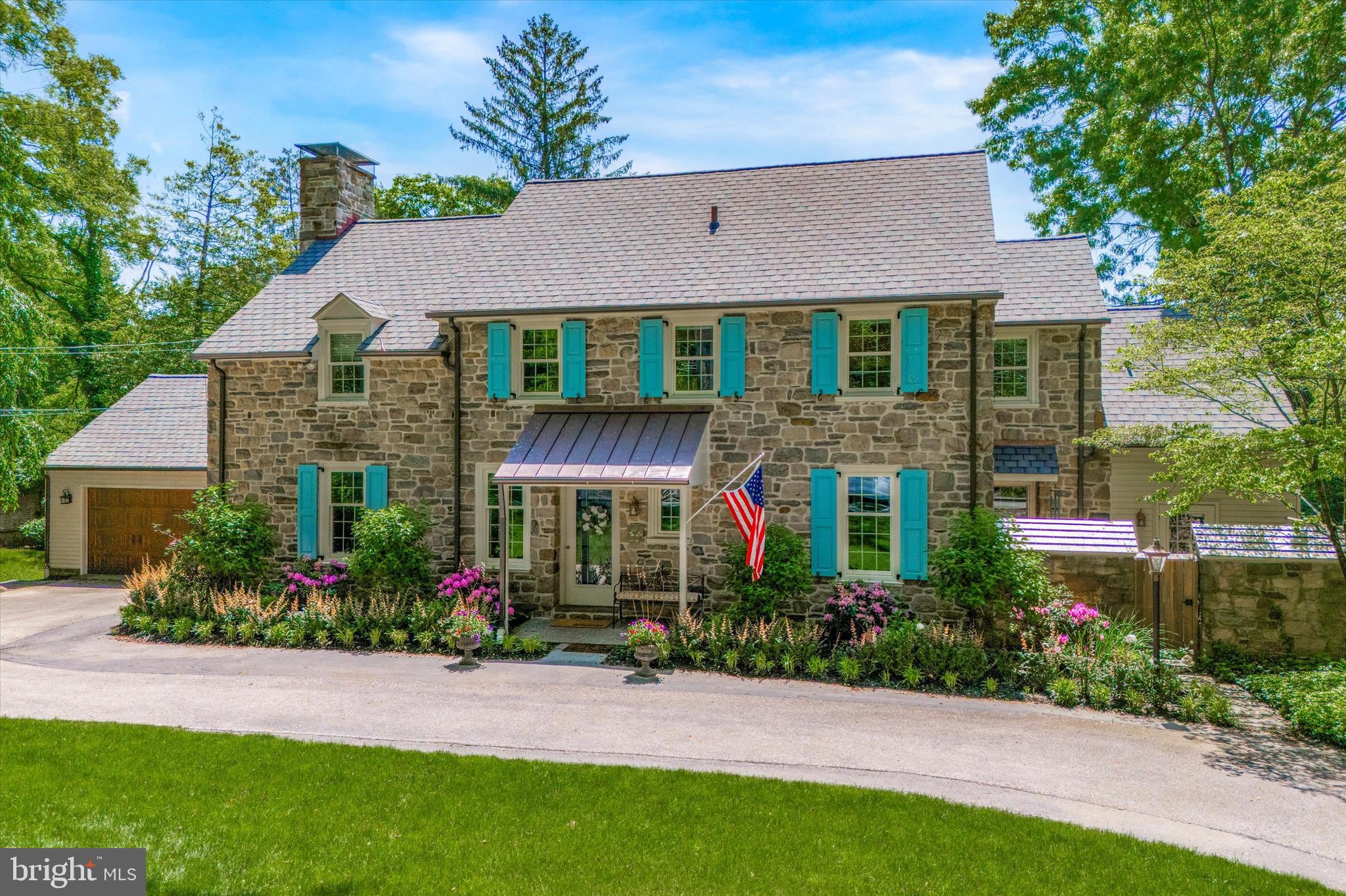 Welcome to 315 Caversham Road! Character and charm abound throughout this lovingly maintained and recently updated center hall stone Colonial, which is ideally located on a private Main Line cul-de-sac and within walking distance to the Bryn Mawr train station, restaurants, shopping, post office, weekend farmer's market, area private schools, Bryn Mawr College, Ashbridge Park and much more! Nestled on a beautifully landscaped 1/2 acre, with specimen trees, stone-walled vegetable garden, and mature landscaping, the property provides both privacy and convenience in a scenic Lower Merion neighborhood. Enter into the foyer with coat closet that leads to both a large office with French doors and custom built-ins and the spacious sun-filled dining room. The dining room opens to the large living room which has a wood burning fireplace and access to a lovely sunroom which overlooks a flagstone patio and the spacious, flat backyard. The sunroom is a year-round space thanks to heaters and custom interchangeable windows and screens. The sunroom also provides access to the attached oversized two-car garage with additional storage space above. The kitchen, which is open to the dining room, was recently updated with all new stainless steel appliances and boasts a breakfast nook. Adjoining the kitchen is a sizable mudroom with separate exit, containing laundry, built-in cubbies, wet-bar, and desk area. There is also a charming, enclosed flagstone courtyard off the mudroom as an additional option for al fresco dining near a separate grilling area. In addition to the first floor living space, the basement, which has been completely renovated by the current owner, includes a walk-out au pair suite with full bath, large playroom/additional family room, bespoke wine cellar and exercise room. The second floor boasts 4 bedrooms, including a lovely primary suite and a primary bathroom with double vanity, soaking tub, and custom frameless glass shower. One of the bedrooms is currently used as an antechamber to the master, with custom built-ins serving as additional closet space and a sitting room/second office. Two additional updated bathrooms round out the second floor.  Coupling yesteryear's charm with today's amenities in a coveted location, this distinctive home is truly a 'must see' for the discerning buyer.