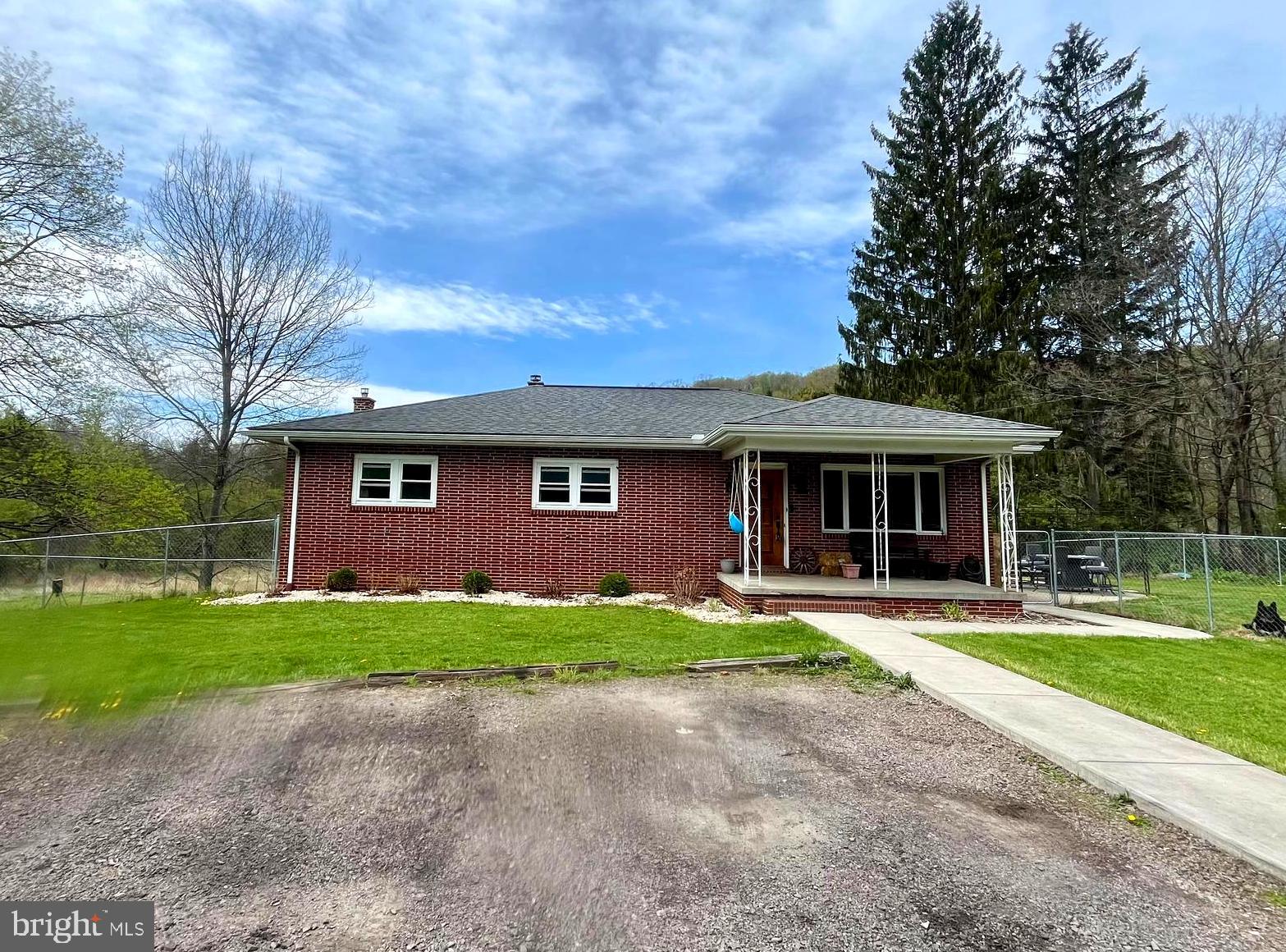You can have the best of both!  Come home to the country on your 2.5 acres of picturesque stream front land on a short no outlet road, AND have the ease of being barely a mile to Interstate 68 and the historic town of Grantsville.  Enjoy easy care with a solid brick build and lots of recent kitchen, bath, and lighting updates, along with sturdy hardwood floors.  Double your square footage for recreation or storage as you use the clean & dry full basement with bath already installed & a wood stove that can heat the entire house, if you like.  Have peace of mind with a huge chain link fenced area on three sides.  With unrestricted land consider a garden or a few animals, and utilize the handy shed and small workshop/barn located on the extra piece of land on the other side of the country road.  Make this your easiest move ever with this well maintained, convenient & comfortable home, where there's plenty of room to roam your creek front land.