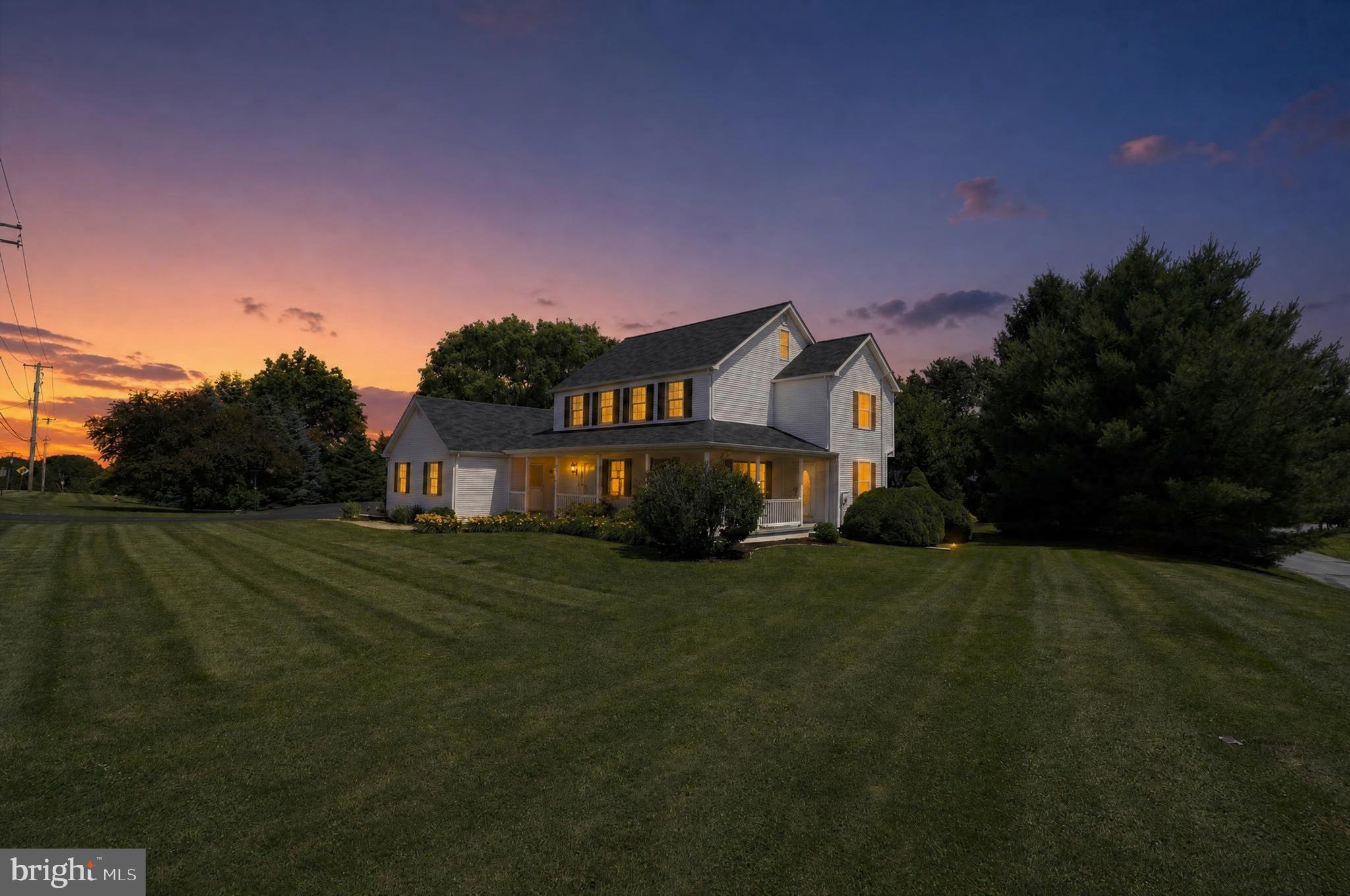 Stunning Colonial-style Next Gen home for sale featuring 5 bedrooms, 3.5 bathrooms, a private in-law / Next Gen suite, and a detached 3-car garage, all set on a beautiful flat 0.83-acre lot—perfect for multi-generational living, flexible lifestyles, and car enthusiasts alike. From the moment you arrive, you’ll be captivated by the charming wraparound front porch, ideal for morning coffee, relaxing afternoons, or unwinding at the end of a busy day. Step inside to a spacious and inviting living room, then continue into the heart of the home where an open-concept floor plan showcases a large eat-in kitchen overlooking the family room—perfect for entertaining and everyday living. The formal dining room provides an elegant setting for holidays and gatherings, while a convenient half bath completes the main level. Designed with today’s buyers in mind, this Next Gen home with its own private suite offers incredible flexibility. The suite features its own entrance, kitchenette, living room, bedroom, and bathroom—ideal for multi-generational living, guest space, home office, or au pair accommodations. A generously sized laundry/mudroom provides access to a covered walkway leading to the detached 3-car garage, a true standout for car enthusiasts, hobbyists, or additional storage needs. Off the kitchen, step outside to a spacious, partially covered Trex deck overlooking a level 0.83-acre backyard, creating the perfect outdoor setting for entertaining, relaxing, or designing your dream backyard oasis. Upstairs, retreat to the primary bedroom with en suite bathroom, along with three additional bedrooms and a shared hall bath. A major bonus is the walk-up attic already plumbed for a bathroom, offering incredible potential for additional living space, home office, or bonus room. The home also includes a full unfinished basement with bilco doors and backyard access, providing even more opportunity for customization. Recent upgrades include a new water heater, HVAC system, Trex deck with covered roof, and a newer roof, offering added value and peace of mind. This Next Gen home with an in-law suite and large yard blends timeless charm with modern living and exceptional flexibility—schedule your private showing today!