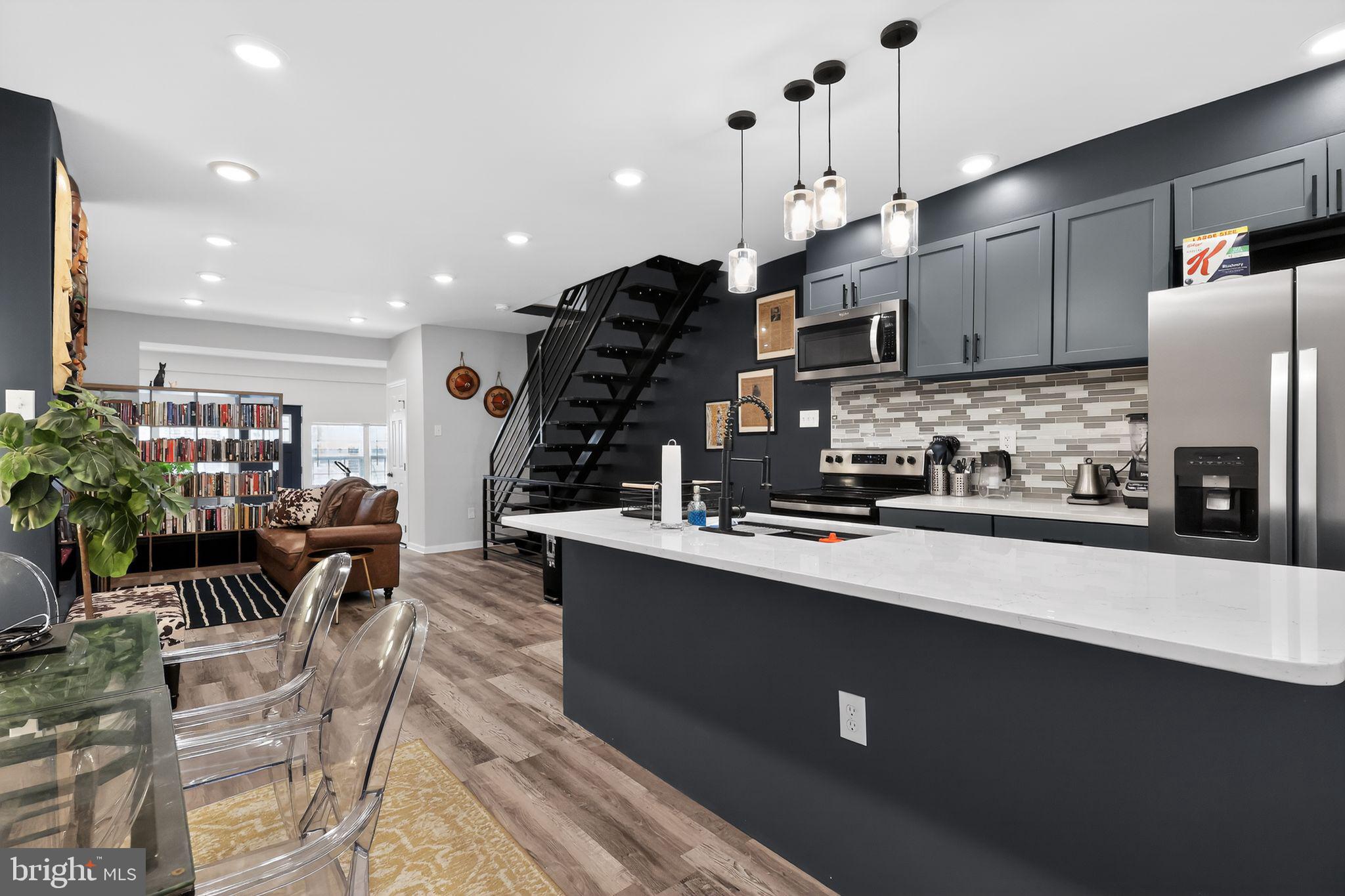 Welcome to this stunning, fully renovated 4-bedroom, 2.5-bath modern row home located in the highly desirable Kingsessing section of Philadelphia. Thoughtfully reimagined with upscale finishes and contemporary design throughout, this move-in-ready residence offers the perfect blend of comfort, functionality, and elevated modern living.

Step inside to an expansive open-concept main level featuring wide-plank luxury flooring, recessed lighting, and a striking custom fireplace feature wall that serves as a bold architectural centerpiece. A dramatic floating steel staircase adds a refined modern-industrial touch, bringing both character and visual distinction to the space.

The chef-inspired kitchen is fully tiled and impeccably appointed with Whirlpool fingerprint-resistant stainless steel appliances, custom modern cabinetry, a designer tile backsplash, pendant lighting, industrial-style fixtures, and a premium gunmetal workstation sink—curated for both everyday living and elevated entertaining.

A stylishly designed powder room is conveniently located on the main level, thoughtfully positioned for guests and daily functionality.

Just beyond the kitchen, a sliding barn door opens to a private rear deck and backyard retreat, creating a seamless indoor-outdoor flow ideal for entertaining or relaxing in privacy.

The fully finished lower level expands the home’s versatility with sleek tile flooring, a full bathroom, and a dedicated laundry area complete with washer and dryer. Perfectly suited for a guest suite, home office, gym, media lounge, or additional family living space, this level also presents a unique opportunity for house hacking or multi-generational living—allowing an owner-occupant to comfortably live downstairs while renting out the upper levels for supplemental income potential.

Upstairs, generously sized bedrooms provide comfort and flexibility, while the secondary bedrooms share a beautifully updated full bath featuring modern finishes and clean contemporary design.

The spacious primary suite is a true standout, offering an oversized layout paired with a large walk-in closet—delivering both luxury and practicality rarely found at this price point.

Enjoy peace of mind with brand-new HVAC, electrical, plumbing, and roofing systems—offering years of low-maintenance, worry-free living.

Situated on a quiet residential block that has recently benefited from neighborhood improvements, including newly completed sidewalks and curb enhancements, the property offers strong curb appeal and a refreshed streetscape environment. Conveniently located near parks, schools, shopping, public transportation, major commuter routes, and Center City Philadelphia.

Whether you’re a first-time homebuyer searching for a turnkey modern home or an investor seeking a strong rental opportunity, this property offers exceptional flexibility, value, and long-term potential.

5637 Belmar Terrace represents modern Philadelphia living at its finest. Schedule your showing today.

Private appointments are available upon request for qualified buyers to ensure a seamless and flexible viewing experience.