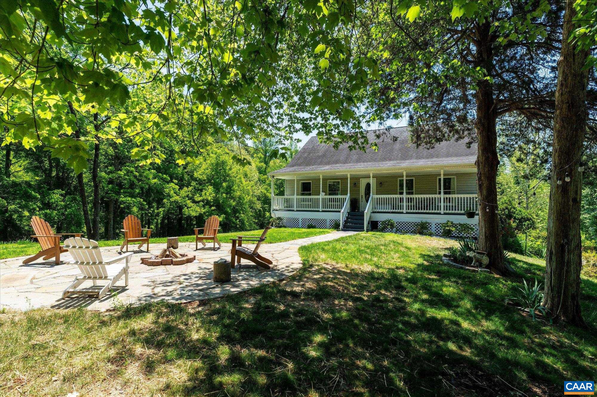 Tucked away on nearly 5 private acres in Albemarle County, this beautifully maintained country retreat offers the perfect blend of peaceful rural living and everyday convenience. Minutes from Preddy Creek Park, and close to NGIC, Pantops & Hollymead, the property feels like a world of its own- a true private oasis surrounded by nature. Overlooking a stocked pond and open pasture, this charming homestead invites you to slow down and enjoy the outdoors from the expansive covered front porch, rear deck, or custom stone fire pit patio. Inside, the home has been thoughtfully renovated with updated flooring, kitchen, bathrooms, appliances, and more. The main level features a primary suite with brand new bathroom, and open living spaces with bamboo hardwood flooring, granite countertops, stainless appliances, and abundant natural light. The finished walk-out basement offers flexibility with a huge family room, full bath, laundry room, bedroom, and ample storage - ideal for guests, multi-generational living, or a potential in-law suite. A rare opportunity to enjoy total privacy, modern updates, and a picturesque farmette setting in one of Albemarle County?s most convenient rural locations.,Granite Counter,White Cabinets