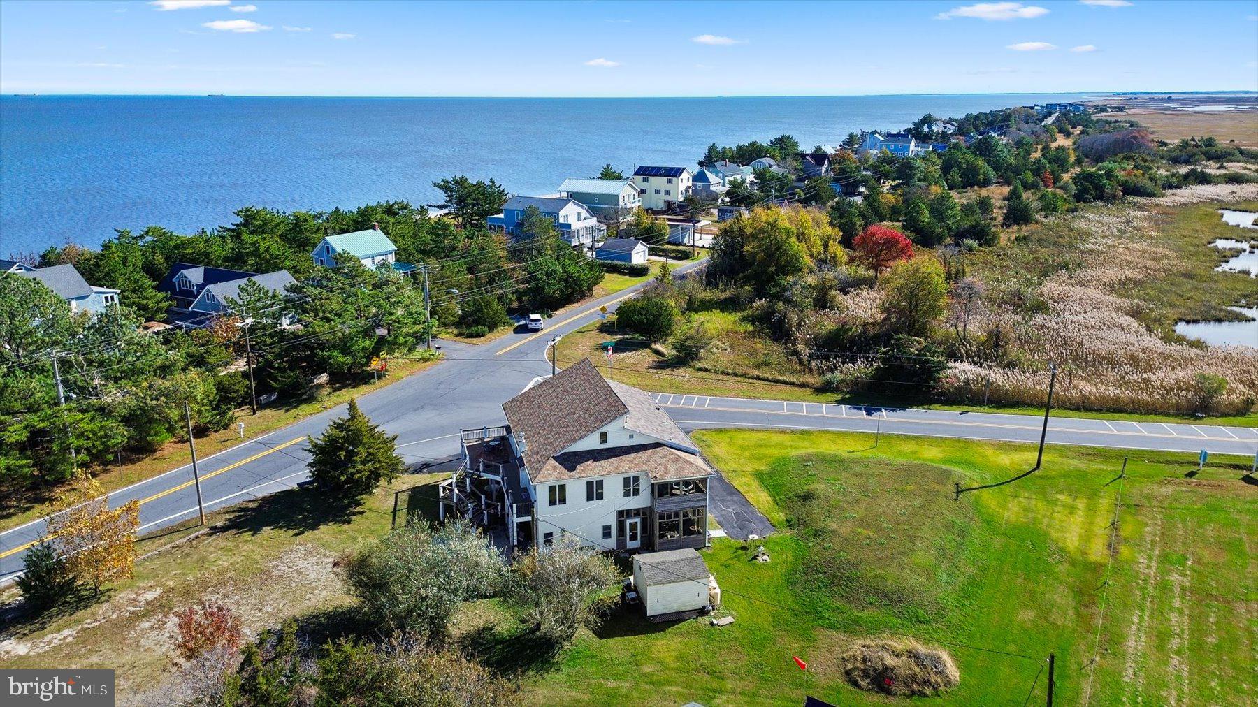 A rare opportunity to own a versatile coastal property in the quiet waterfront community of Slaughter Beach, Delaware. This 4-bedroom, 4-bath home offers a flexible layout designed to accommodate a variety of uses, including vacation rental operations, multi-generational living, owner occupancy with rental income potential, extended family stays, or seasonal use.

Unlike a traditional beach cottage, this home features the option for two complete living levels, each with its own full kitchen and appliances. This unique configuration allows for greater privacy, separation between living spaces, and multiple occupancy possibilities, making it especially appealing for larger groups or owners looking to adapt the property to changing rental demand.

Inside, the home offers an open and comfortable layout with exposed beams, low-maintenance luxury vinyl plank flooring, spacious bedrooms, and abundant natural light. The bathrooms are well-appointed, including features such as a soaking tub and walk-in shower. Major renovations completed in 2018 provide added peace of mind and help reduce near-term capital improvement concerns.

Outdoor living is equally inviting, with a screened porch ideal for morning coffee, relaxing after a day at the beach, or gathering with guests. Situated on a corner lot, the property also offers an asphalt driveway with parking for multiple vehicles.

The location adds to the property’s appeal. Slaughter Beach offers a quieter alternative to Delaware’s more crowded beach markets while still remaining within easy reach of Lewes, Rehoboth Beach, Dover, and regional attractions. A community park located adjacent to the property features pickleball, tennis and basketball courts, along with a playground, creating added convenience and amenities that are attractive for both owners and vacation guests.

Whether your goal is short-term vacation rental use, seasonal occupancy, owner use with supplemental income potential, or long-term appreciation in Delaware’s coastal market, this property offers a level of flexibility rarely found in beach communities. Historical rental information is available to qualified buyers.